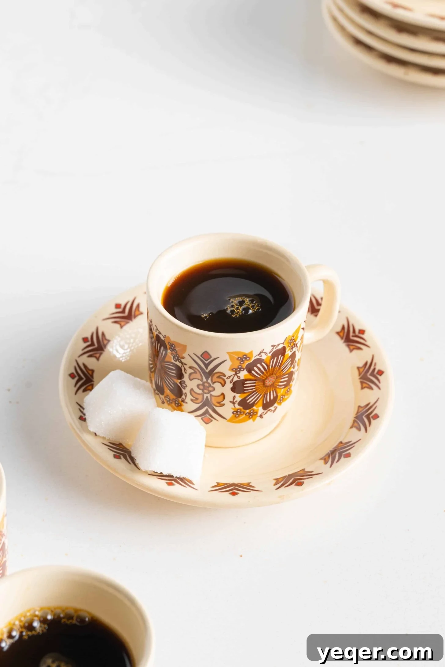 10 Minute Moroccan Coffee Bliss 10 A beautifully composed flat lay of a cup of Moroccan coffee with whole spices and coffee beans scattered around it.
