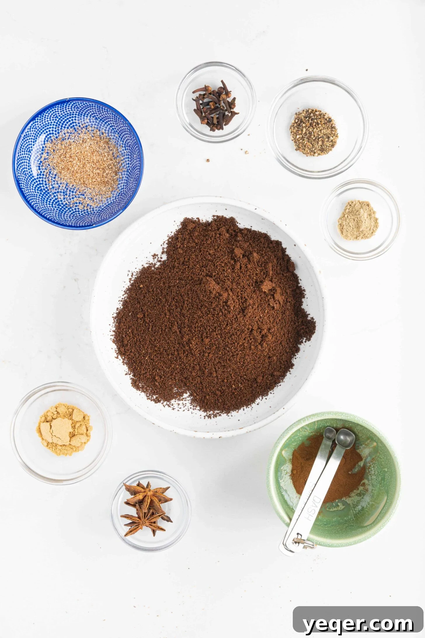 10 Minute Moroccan Coffee Bliss 3 A collection of whole spices and coffee beans laid out on a wooden surface, ready for grinding to make Moroccan coffee.