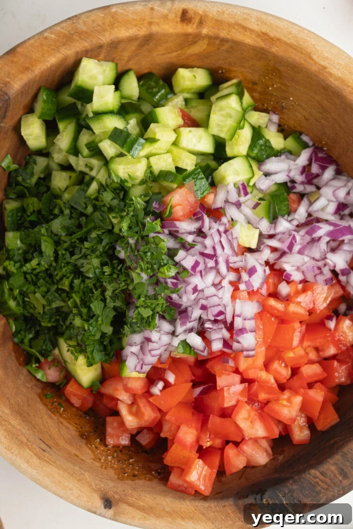Vibrant Moroccan Cucumber Tomato Salad 5 Adding finely cubed tomatoes, cucumbers, minced red onion, and chopped parsley to the prepared dressing.