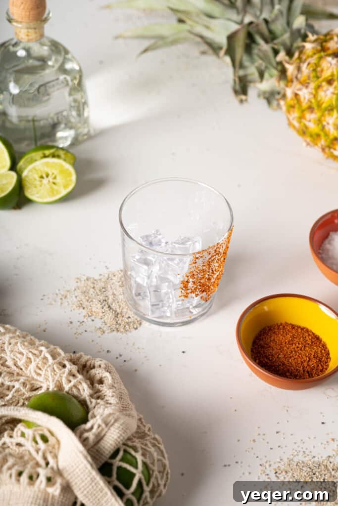 Pineapple Paradise Margarita 3 A glass with Tajin seasoning coating the rim, ready for a pineapple margarita.