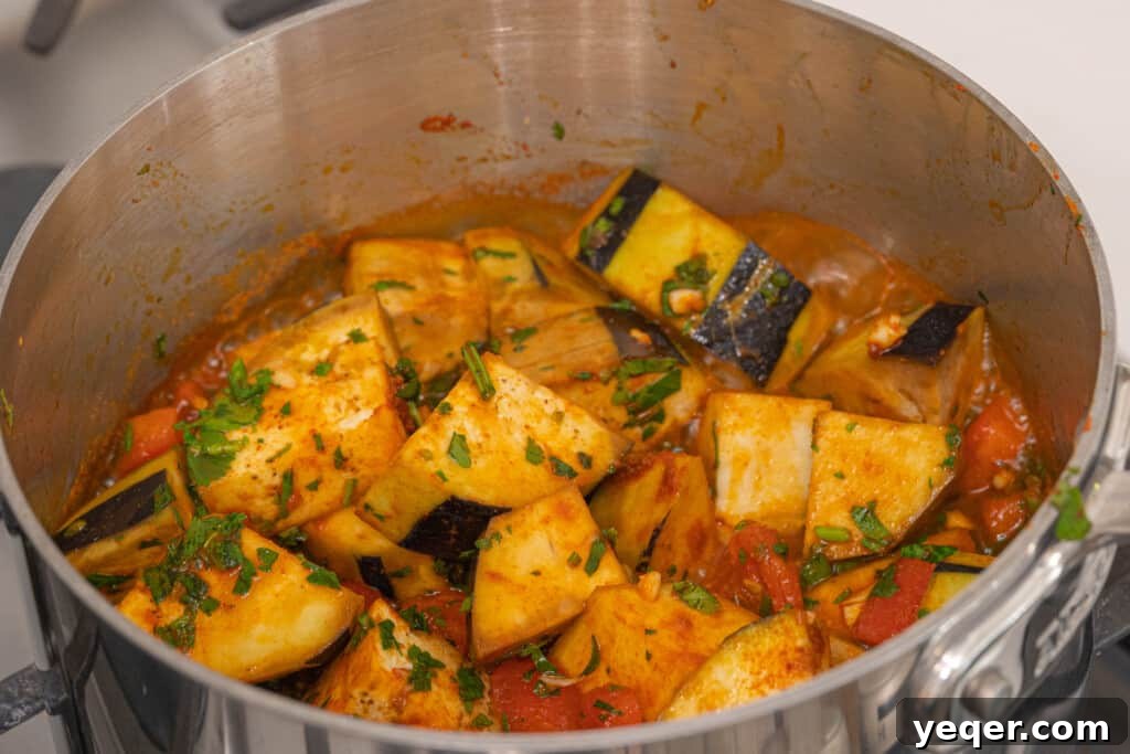 Zaalouk: Flavorful 30-Minute Moroccan Eggplant Dip 5 A stockpot filled with Zaalouk ingredients, simmering gently with the lid on, showing the eggplant and tomatoes softening and reducing.
