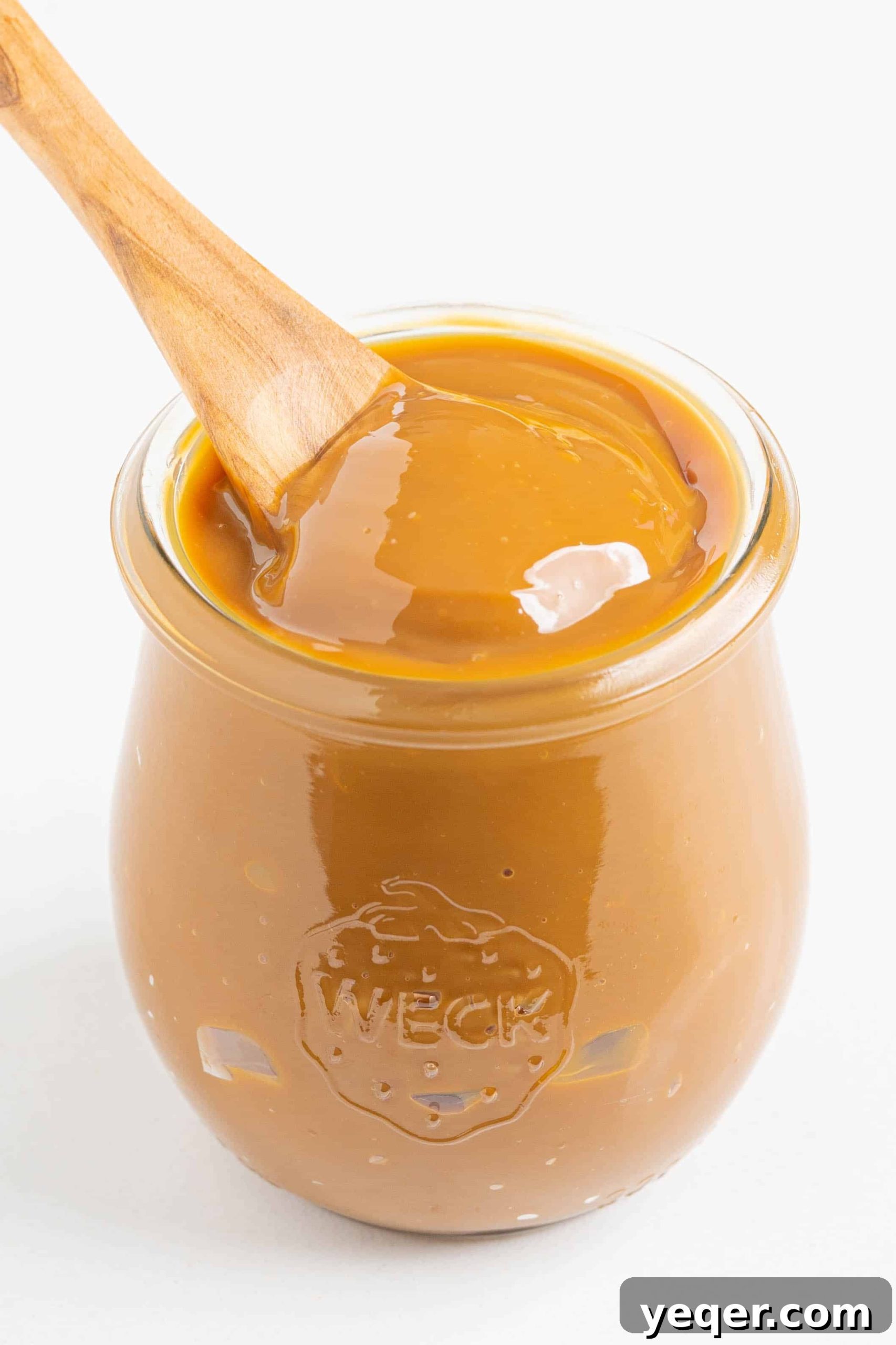 One Ingredient Wonder: Homemade Dulce de Leche Caramel Sauce 2 A beautifully presented jar of homemade dulce de leche, glistening with rich caramel color, ready to be enjoyed.