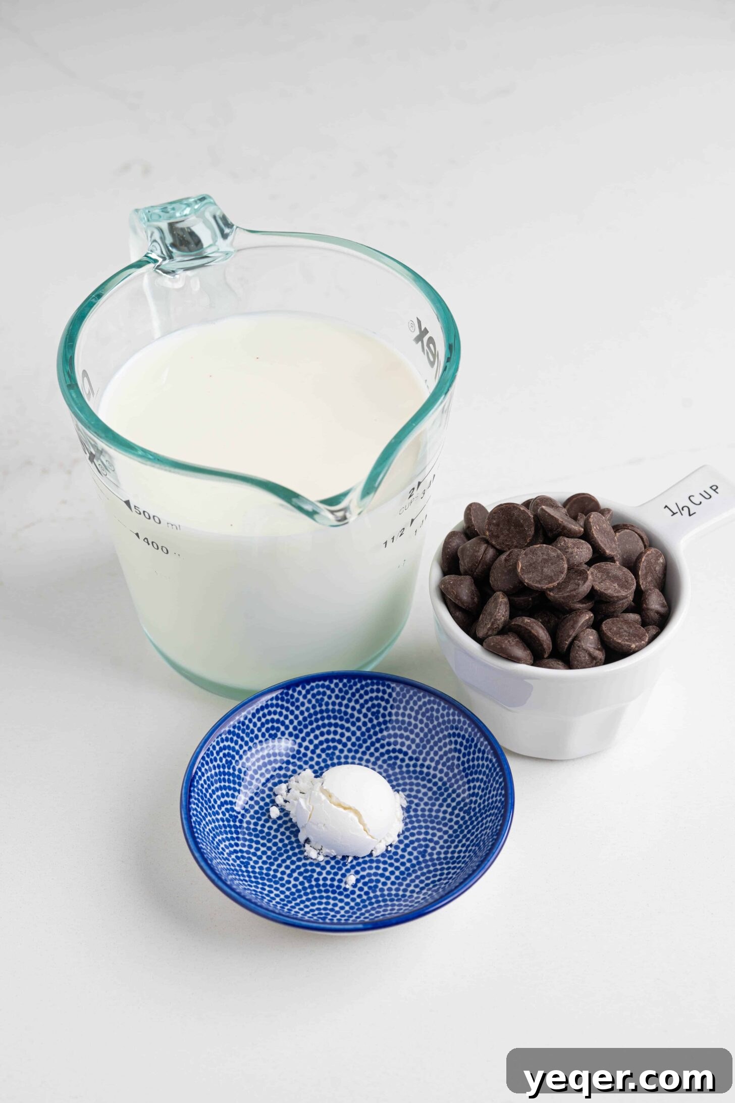 Velvety Spanish Cocoa Indulgence 3 Ingredients laid out for making Spanish hot chocolate: milk, chopped chocolate, and cornstarch