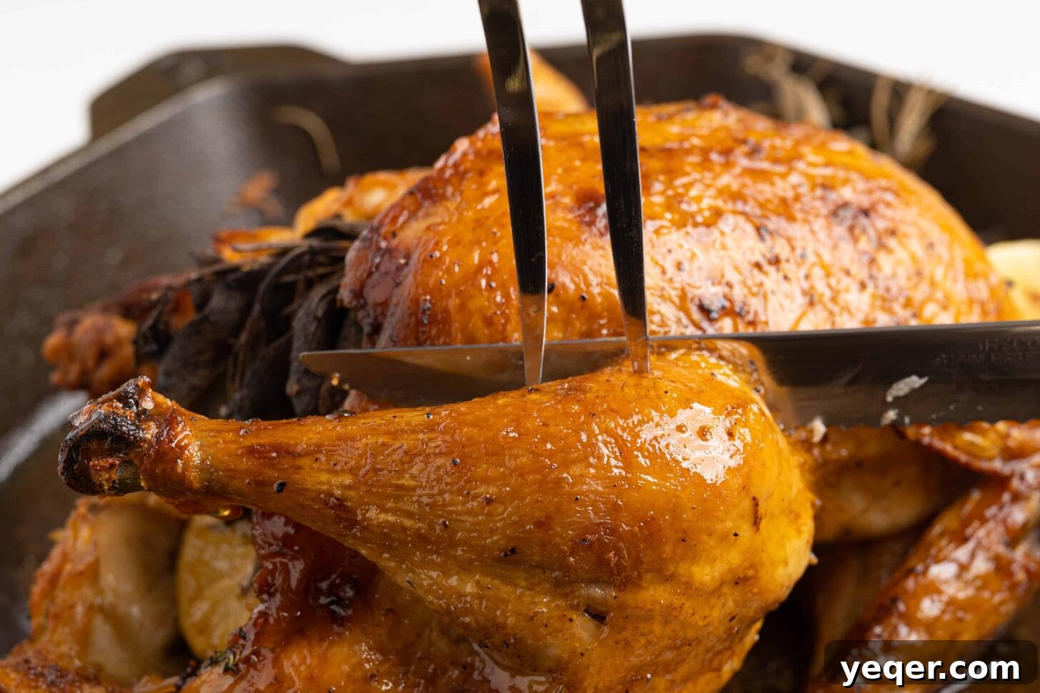 Succulent Golden Roast Chicken 8 A close-up of a roasted chicken being expertly carved into individual servings.
