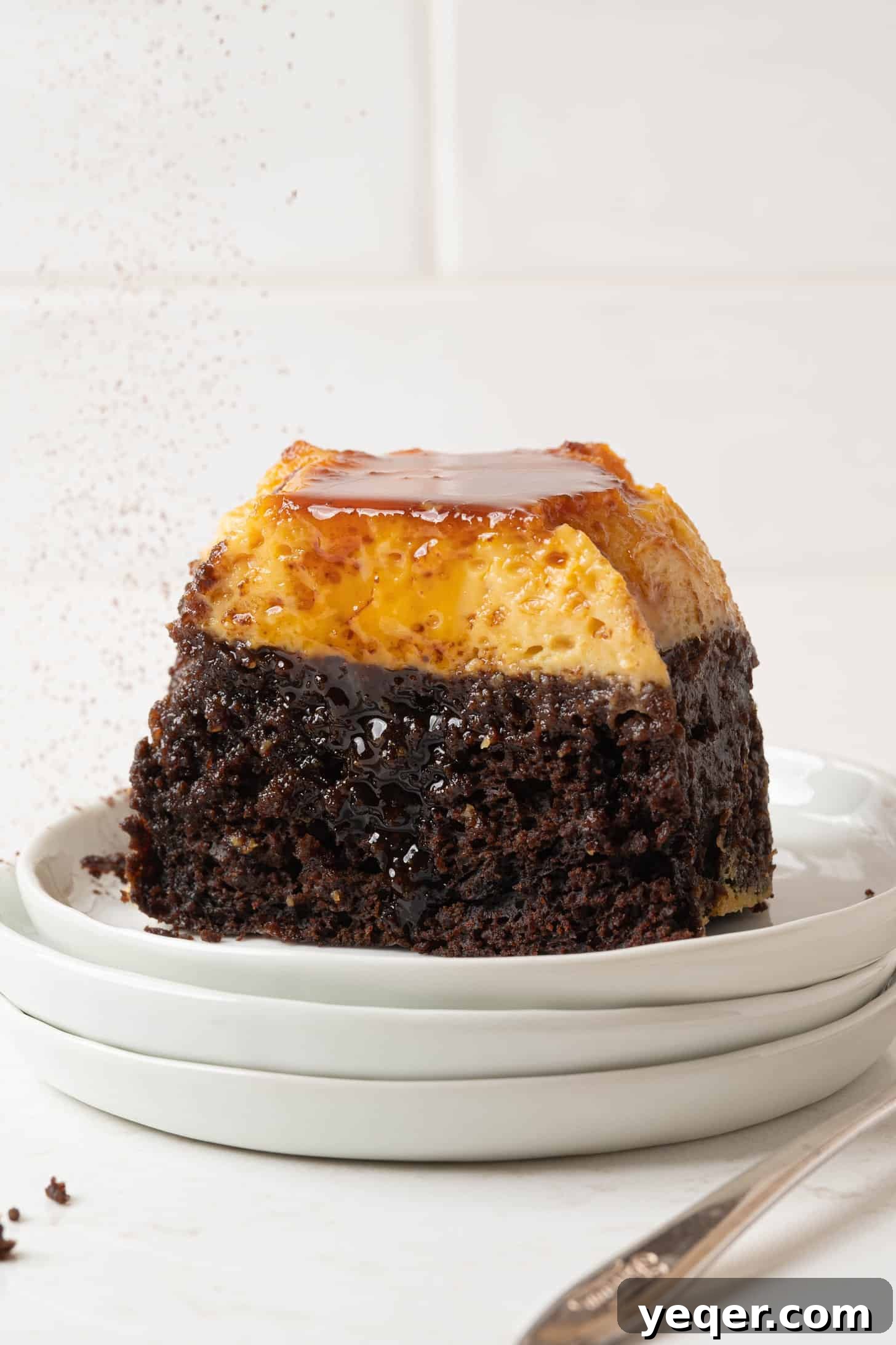 ChocoFlan A Culinary Illusion 12 A whole ChocoFlan, perfectly unmolded and glistening with caramel on a serving platter, ready to be sliced.