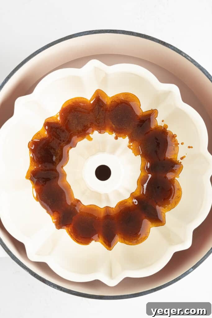 ChocoFlan A Culinary Illusion 5 A bundt pan lined with a shiny, hardened layer of caramel, ready for the cake batter.