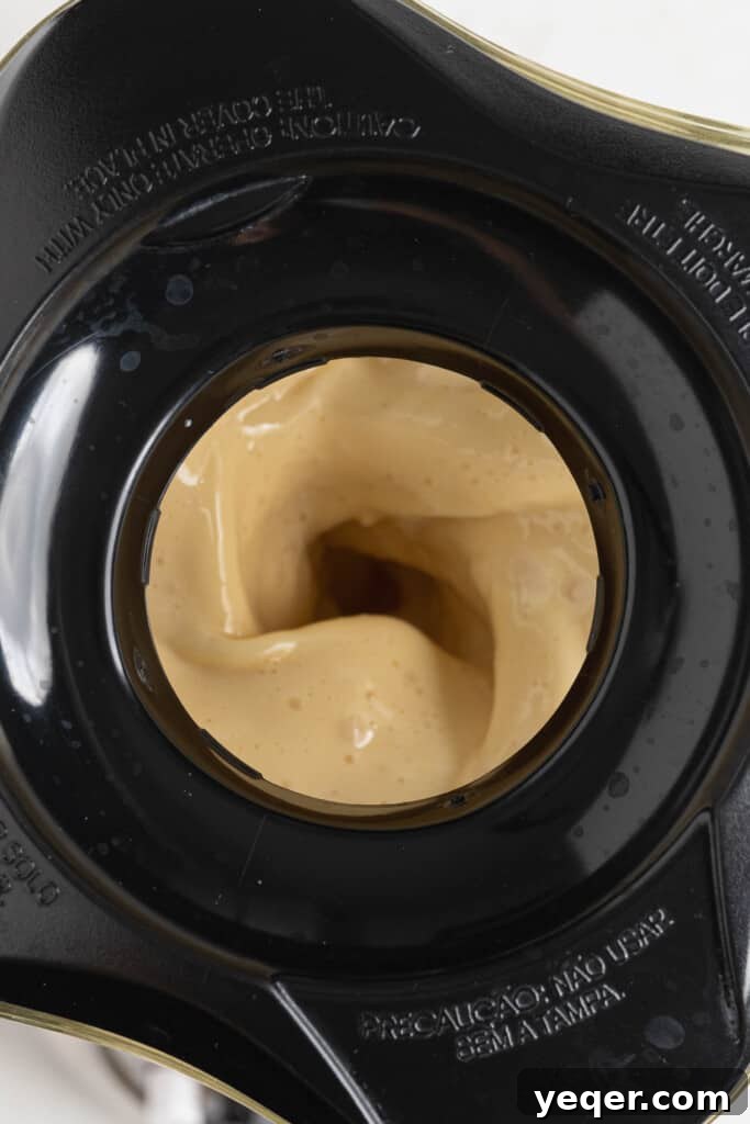 ChocoFlan A Culinary Illusion 7 Flan mixture being blended in a blender, creating a smooth, creamy liquid.
