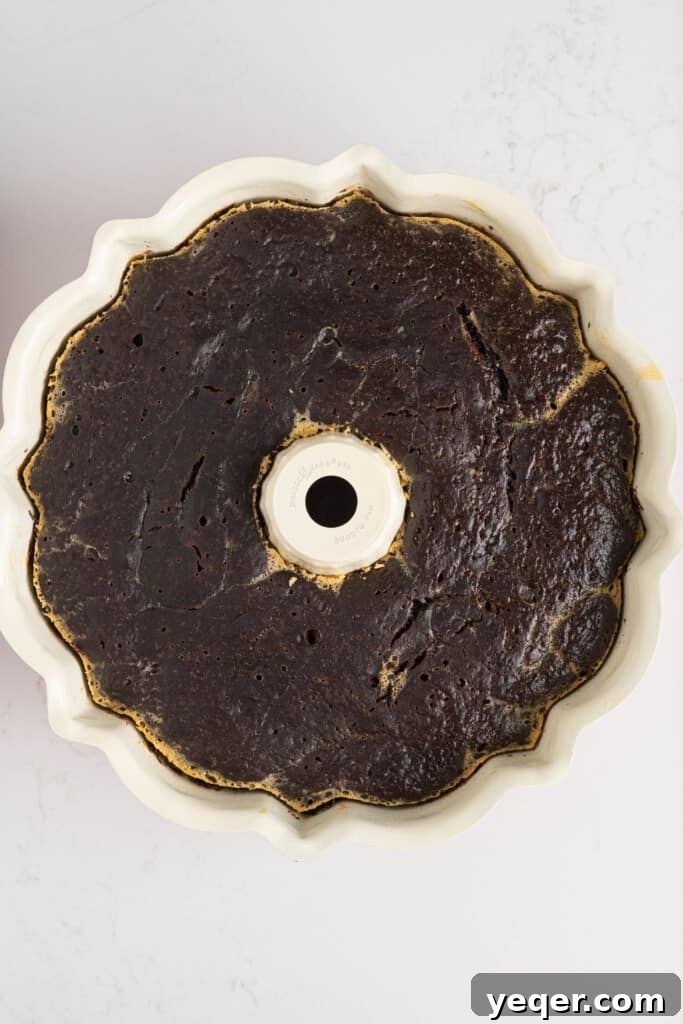 ChocoFlan A Culinary Illusion 8 A baked ChocoFlan, still warm in its bundt pan, showing the distinct chocolate cake layer on top.