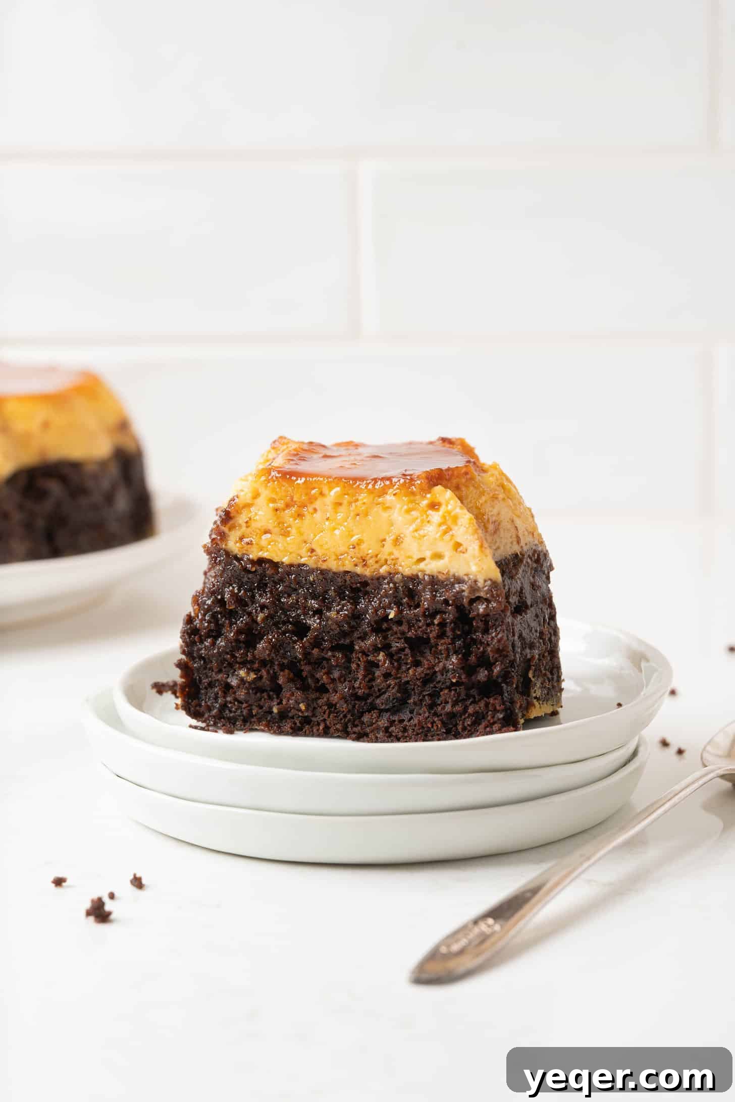 ChocoFlan A Culinary Illusion 10 A close-up shot of a ChocoFlan slice, highlighting the distinct layers of moist chocolate cake and creamy flan, glistening with caramel.