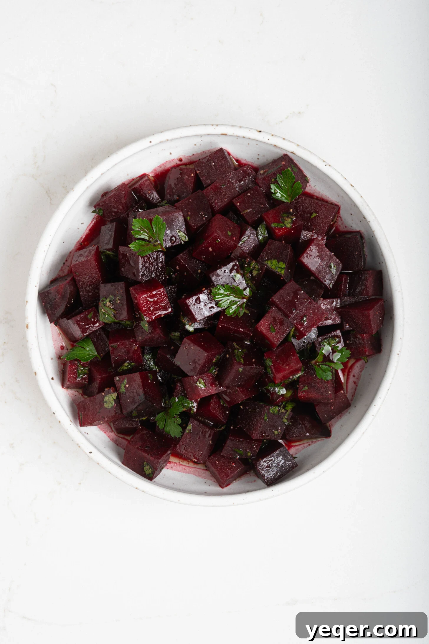 Chilled Moroccan Roasted Beet Salad 10 A large bowl of the finished Moroccan beet salad, garnished with fresh parsley.