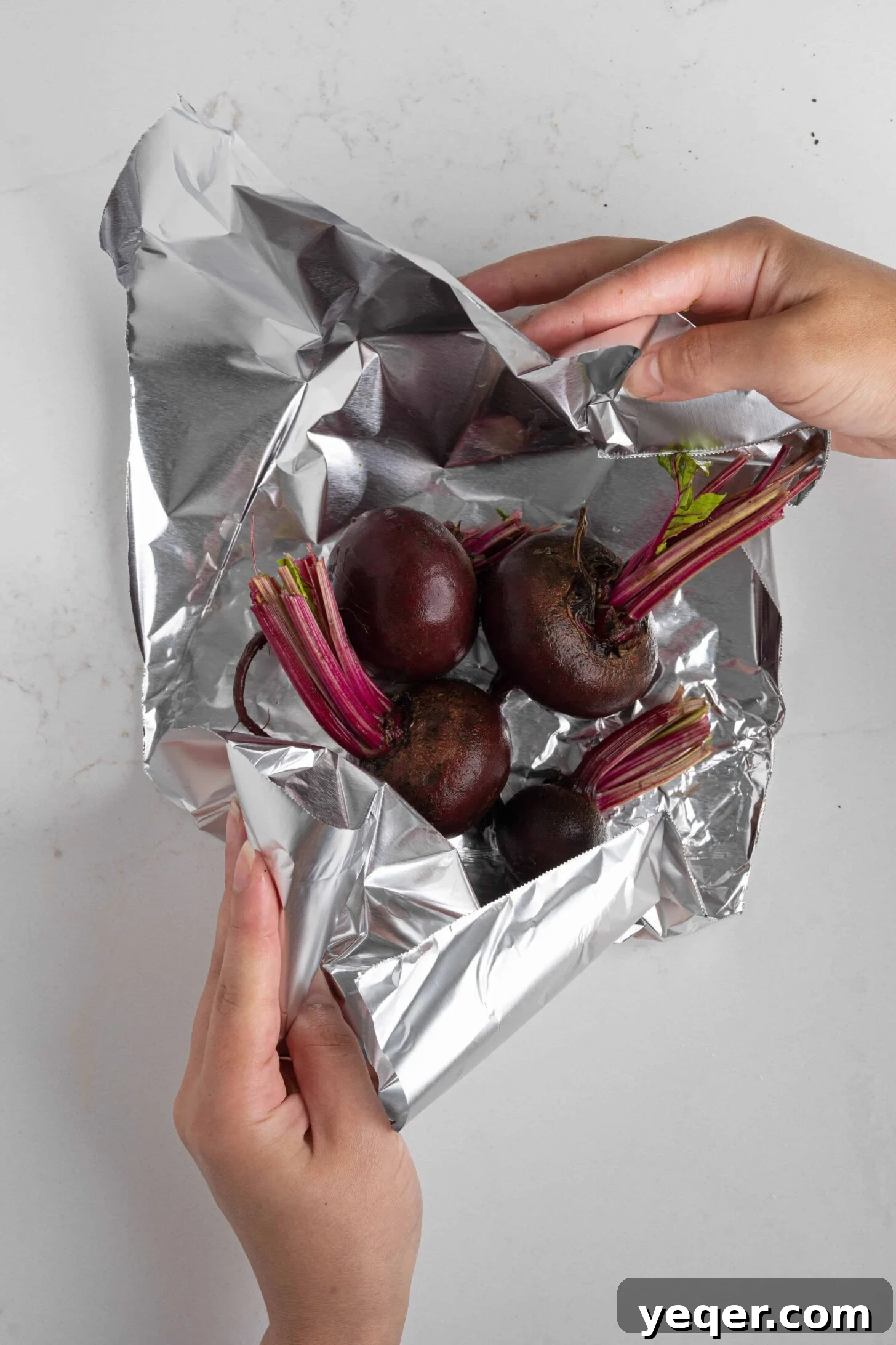 Chilled Moroccan Roasted Beet Salad 4 Fresh beets being wrapped in aluminum foil, ready for roasting.