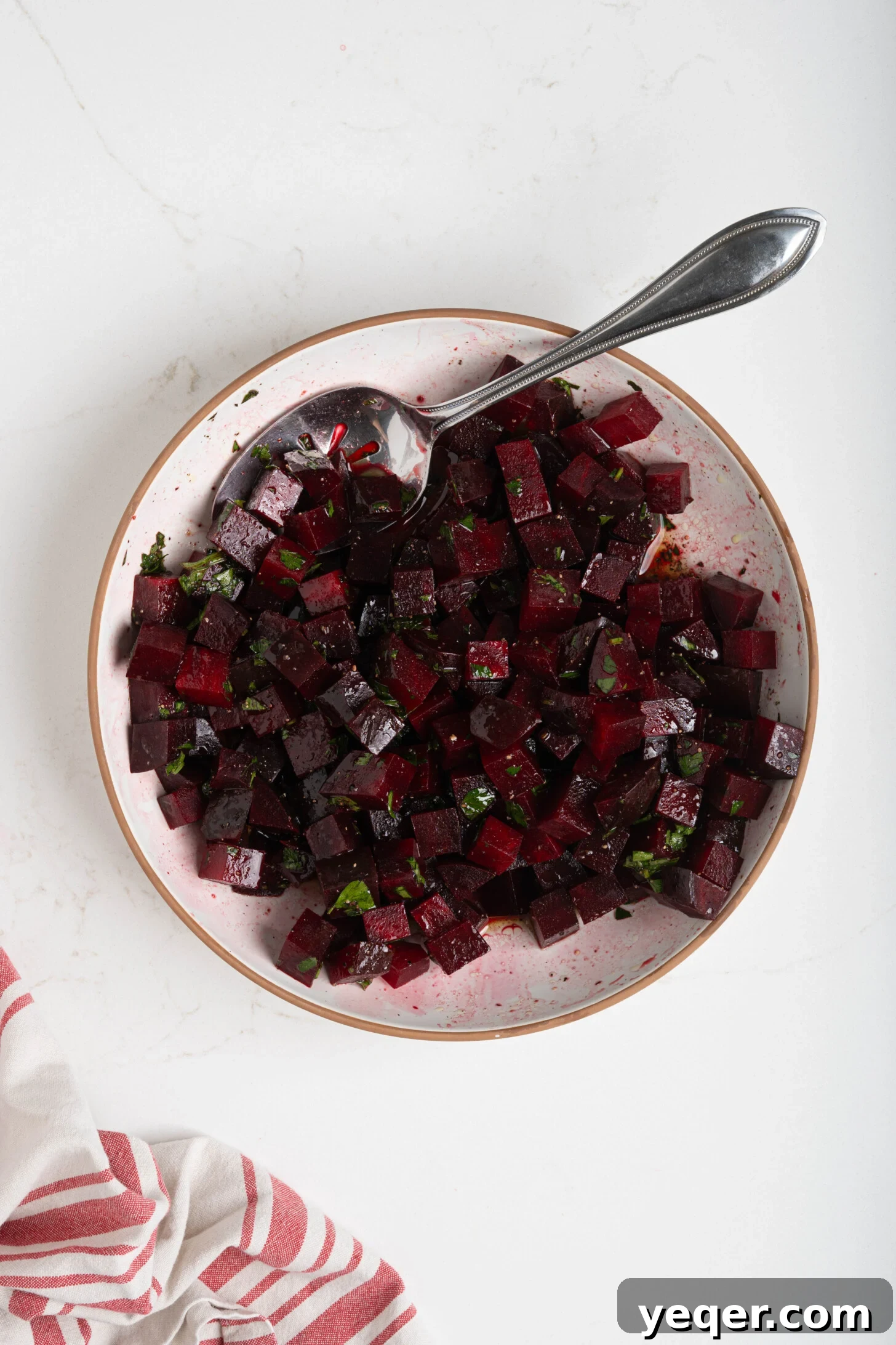 Chilled Moroccan Roasted Beet Salad 7 A bowl of Moroccan beet salad being tossed with the dressing.