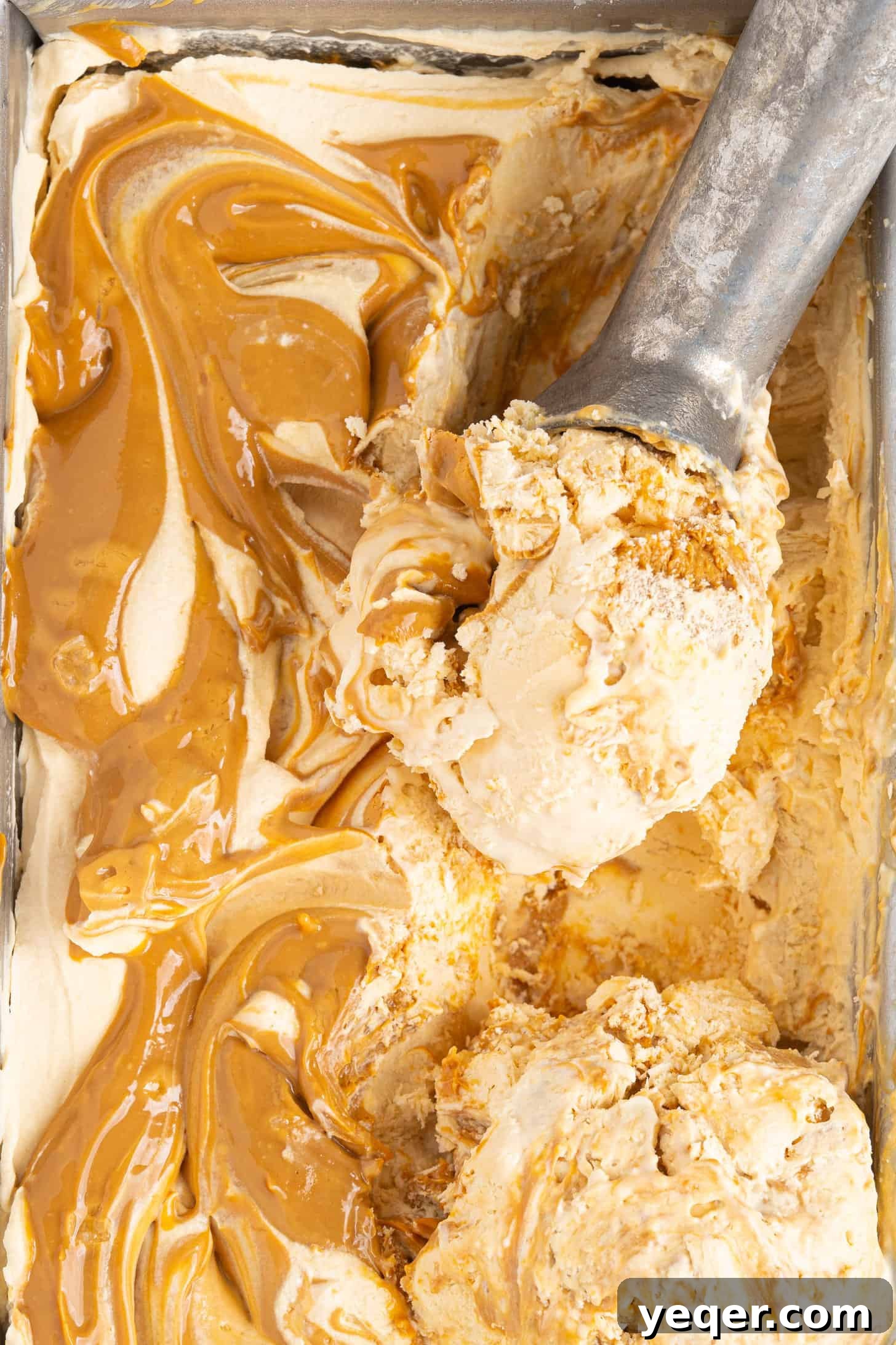 Three-Ingredient Bliss: Dulce de Leche Ice Cream 2 Scoops of homemade dulce de leche ice cream in a bowl, showing caramel swirls