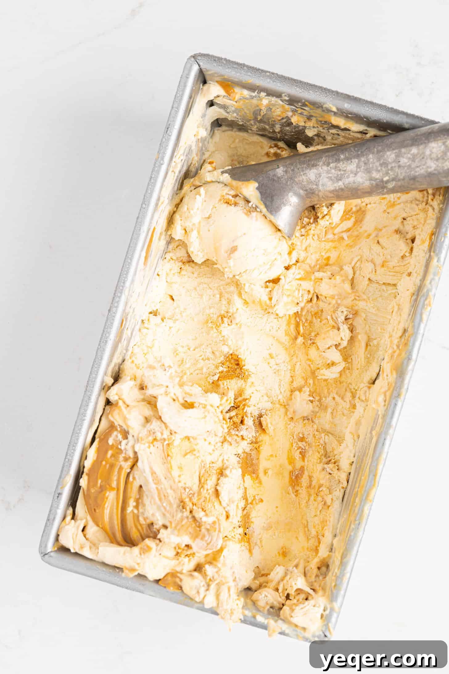Three-Ingredient Bliss: Dulce de Leche Ice Cream 9 A scoop of dulce de leche ice cream showing delicious caramel swirls
