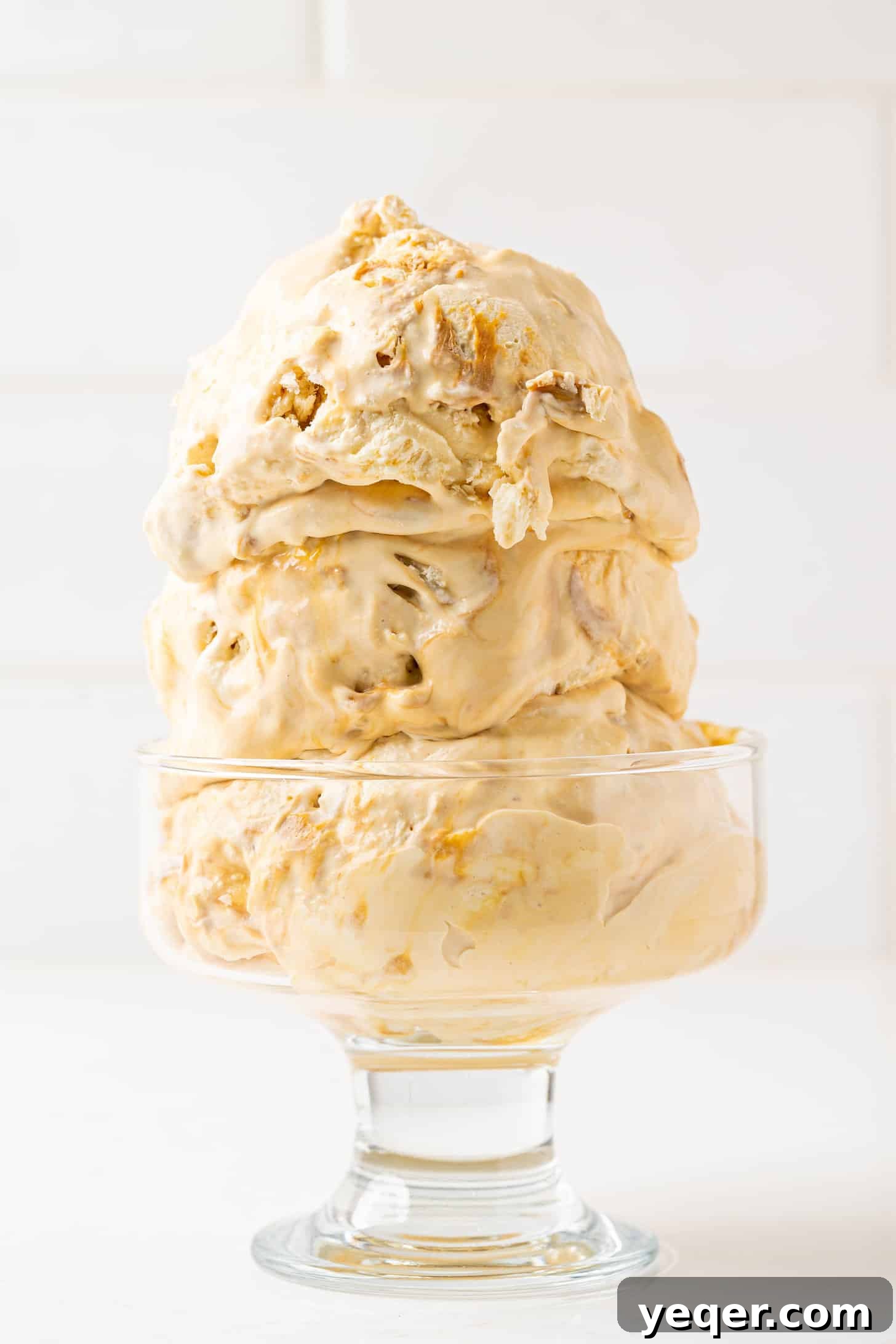 Three-Ingredient Bliss: Dulce de Leche Ice Cream 10 Close-up of a bowl of dulce de leche ice cream with a spoon, highlighting its creamy texture and rich color