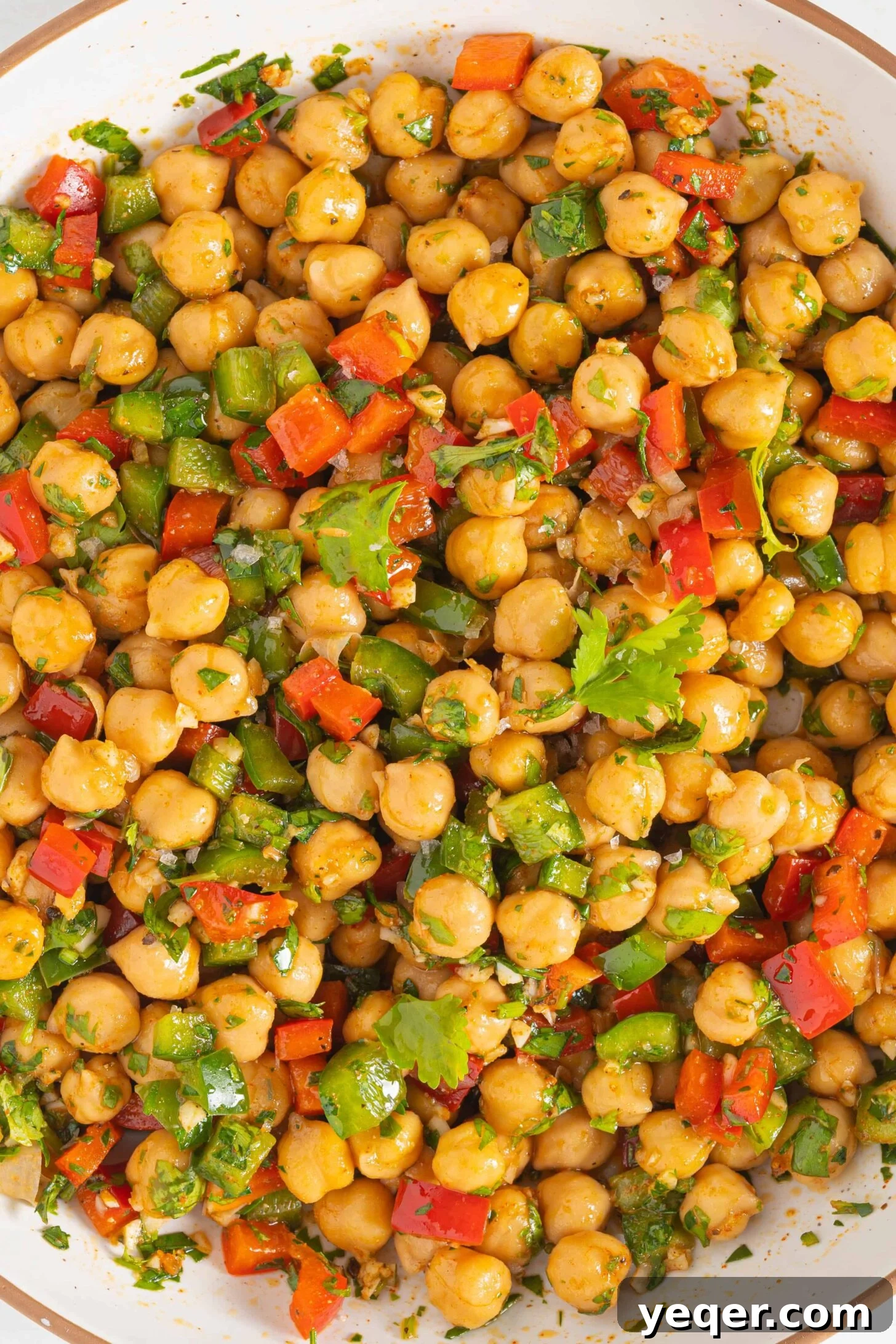 Vibrant 15-Minute Moroccan Chickpea Salad 2 A bowl of vibrant spiced chickpea salad with fresh herbs and bell peppers, ready to be served.