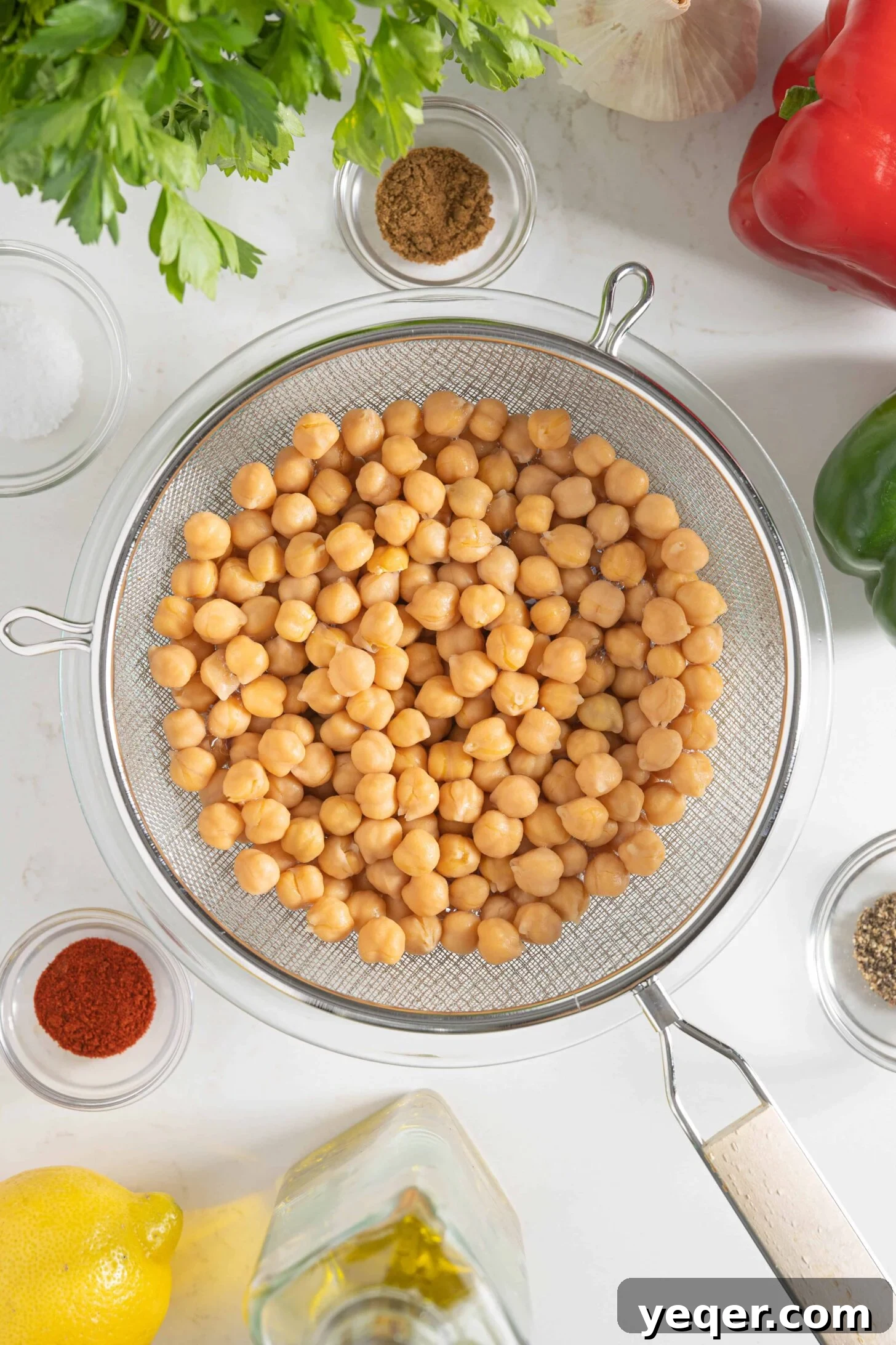 Vibrant 15-Minute Moroccan Chickpea Salad 3 Fresh ingredients laid out for spiced chickpea salad, including chickpeas, bell peppers, herbs, and lemons.