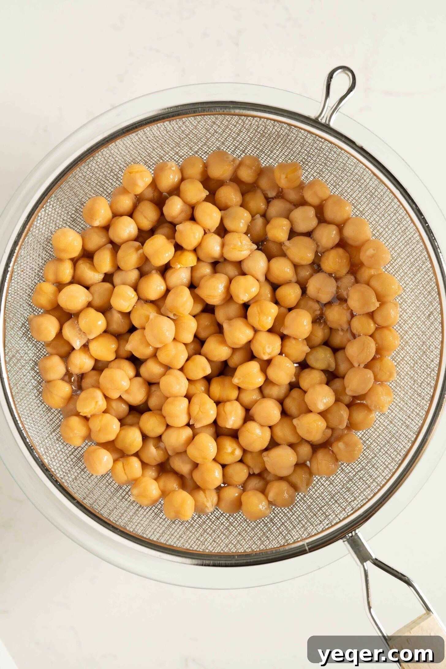 Vibrant 15-Minute Moroccan Chickpea Salad 7 Freshly cooked chickpeas being rinsed in a strainer under running water.