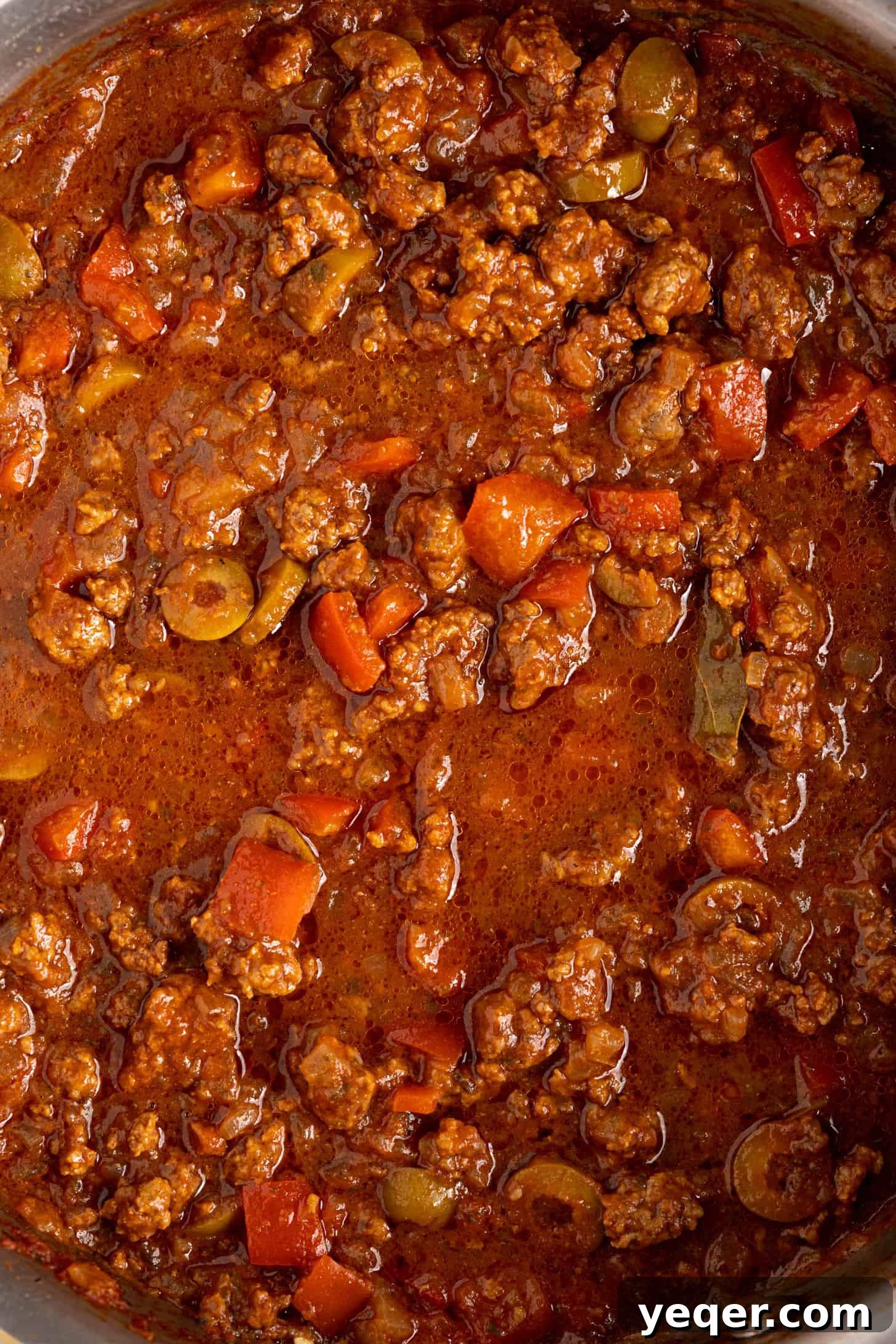 Five-Ingredient Wonder Empanada Dough 15 A close-up shot of a pan filled with rich, savory picadillo filling, showcasing its hearty texture and appetizing colors.