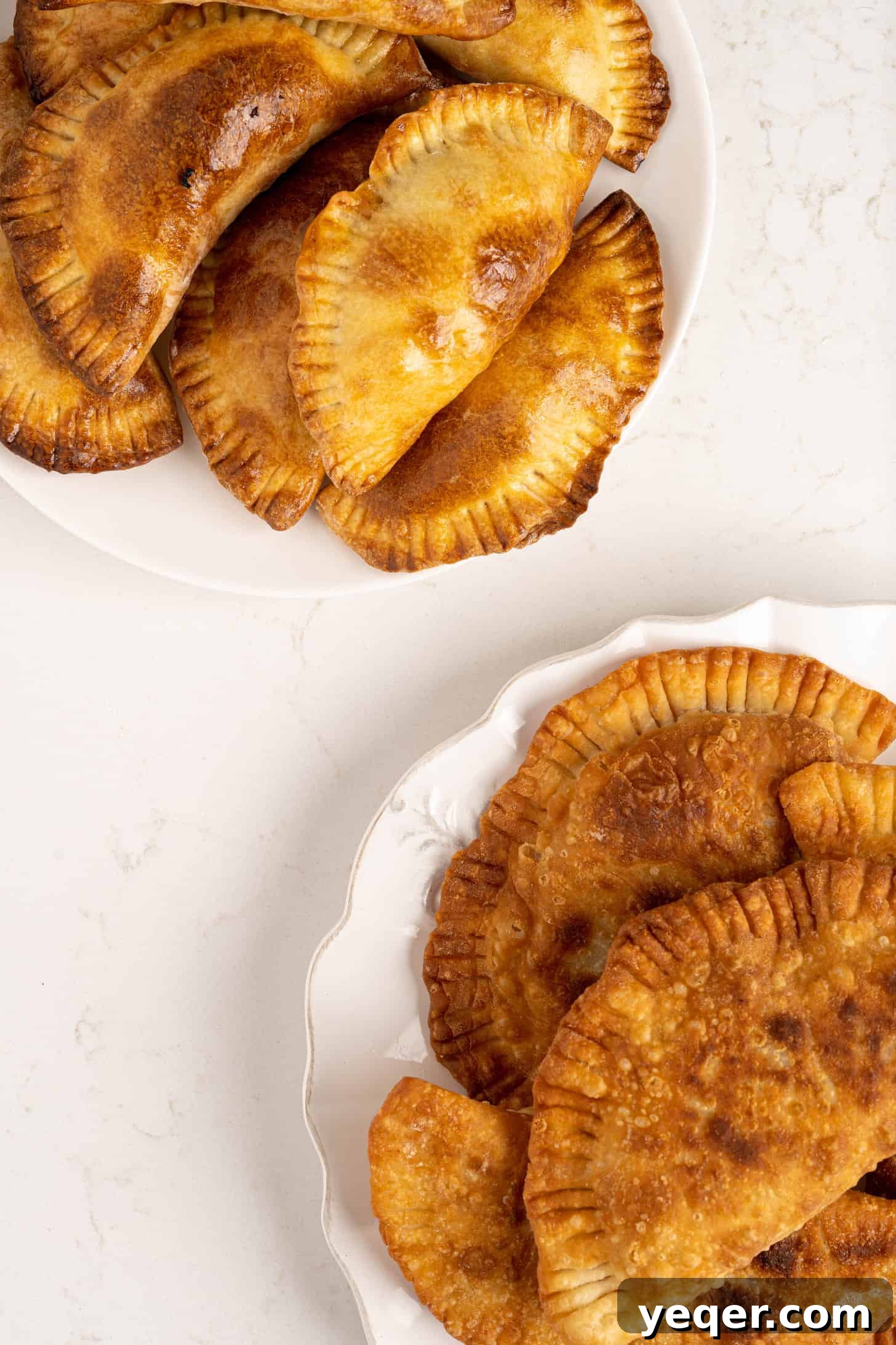 Five-Ingredient Wonder Empanada Dough 17 A beautiful display of assorted empanadas on a rustic serving plate, some baked golden, others fried to a crisp perfection, ready to be enjoyed.
