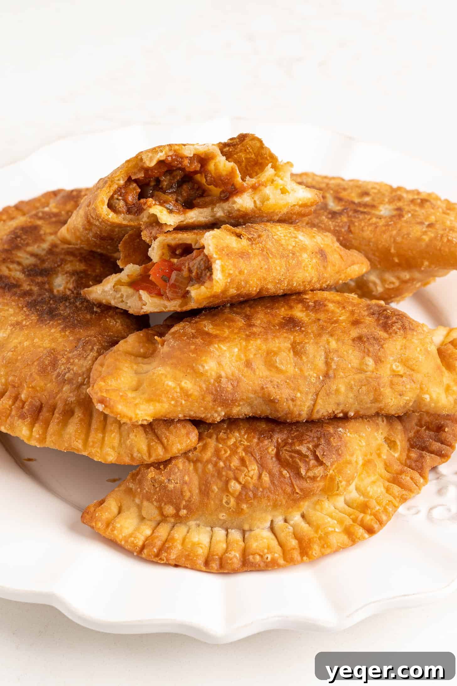 Five-Ingredient Wonder Empanada Dough 20 A rustic plate showcasing several perfectly cooked empanadas, golden and flaky, ready for a delicious meal or snack.