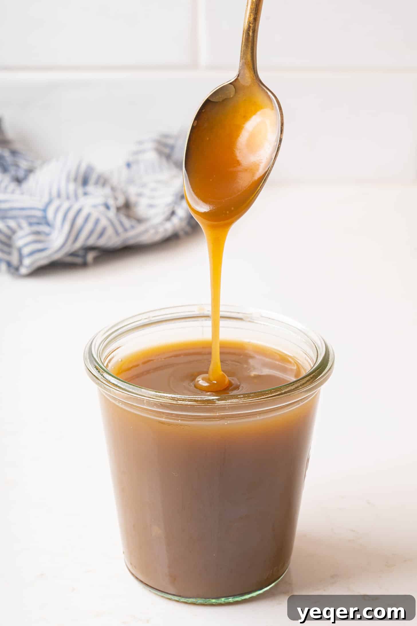 Velvety Vegan Coconut Caramel in 30 Minutes 2 Homemade vegan coconut caramel sauce in a glass jar, ready to be used as a topping.