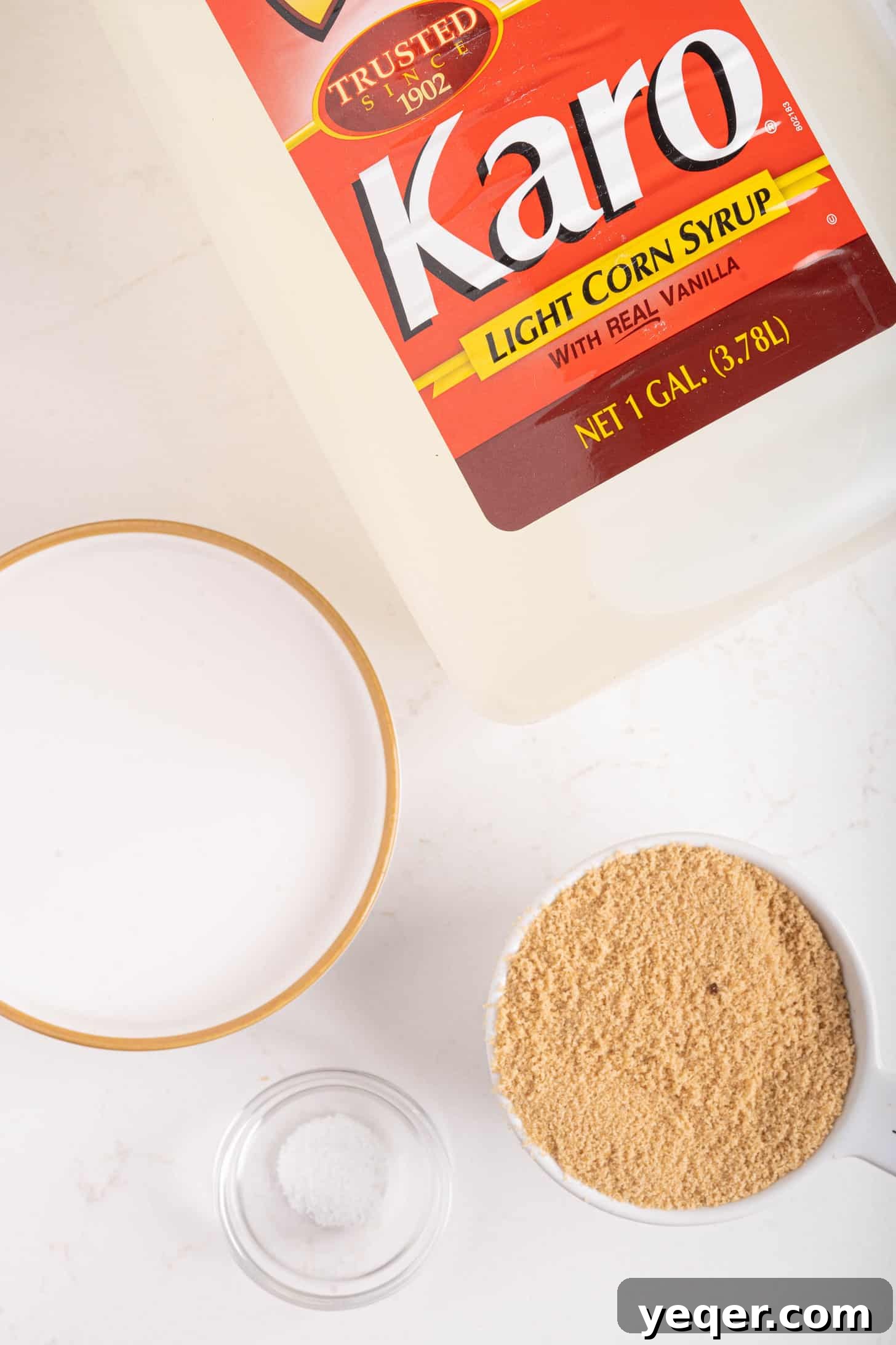 Velvety Vegan Coconut Caramel in 30 Minutes 3 Simple ingredients laid out on a kitchen counter, including a can of coconut milk, sugar, and a bottle of Karo corn syrup, ready for making vegan caramel.