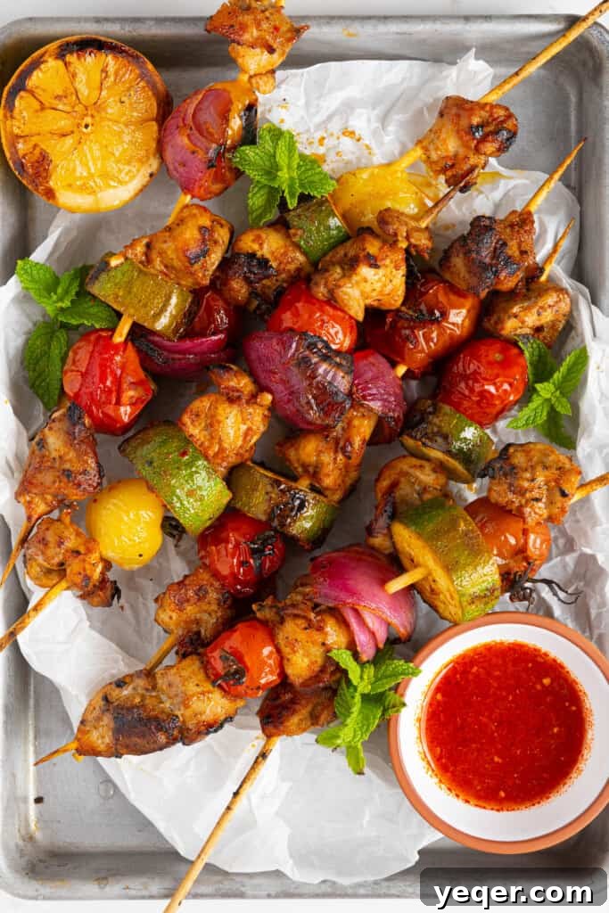 Flavor-Packed Harissa Chicken Skewers in 30 Minutes 8 harissa chicken skewers cooking on a pan