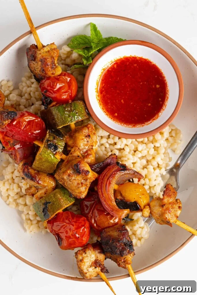 Flavor-Packed Harissa Chicken Skewers in 30 Minutes 9 harissa chicken skewers served over a bed of couscous