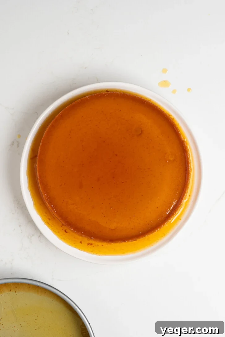 Golden Pumpkin Caramel Flan 11 A finished pumpkin flan, freshly flipped onto a serving platter with caramel dripping down.