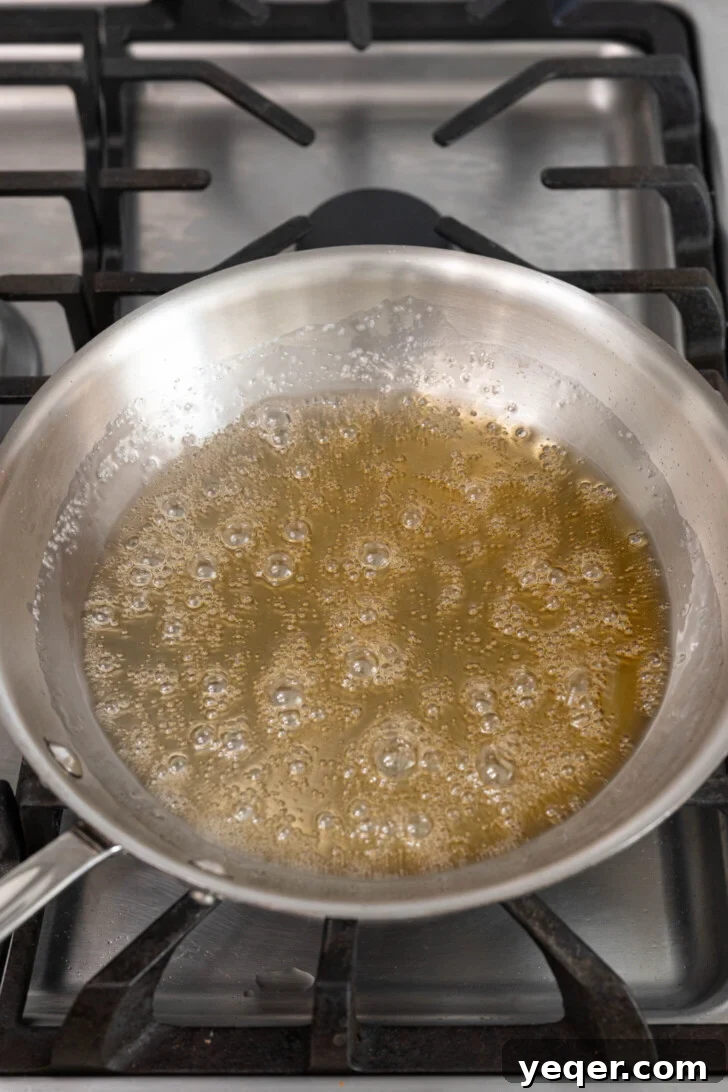 Golden Pumpkin Caramel Flan 5 Caramelizing sugar turning into a light golden liquid in a pan.