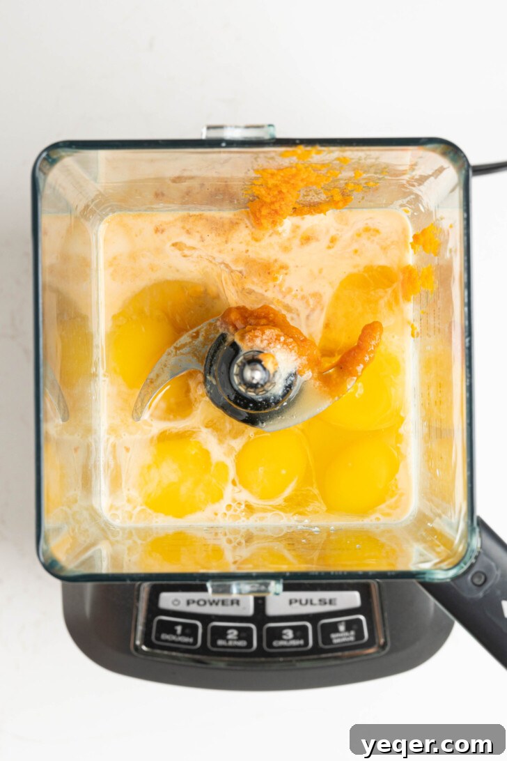 Golden Pumpkin Caramel Flan 8 Pumpkin flan ingredients being blended in a blender jar.
