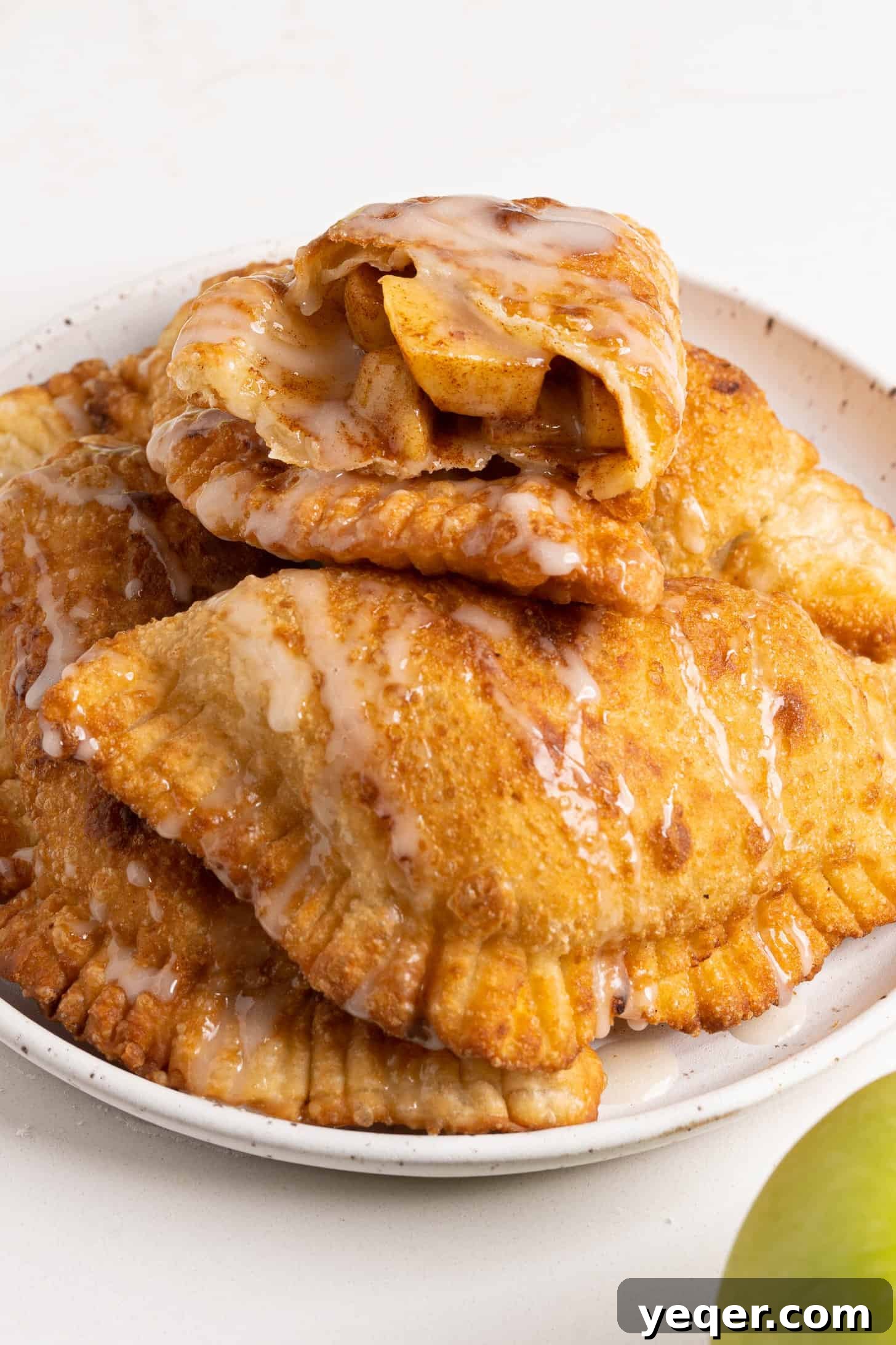 Golden Apple Pastry Pockets 12 A beautifully arranged plate of freshly made apple empanadas, ready to be served.