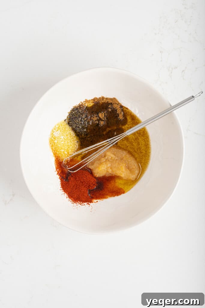 Char-Grilled Lamb Skewers with Tangy Preserved Lemon 4 A bowl filled with Moroccan marinade, featuring finely minced herbs, onion, and spices in olive oil.