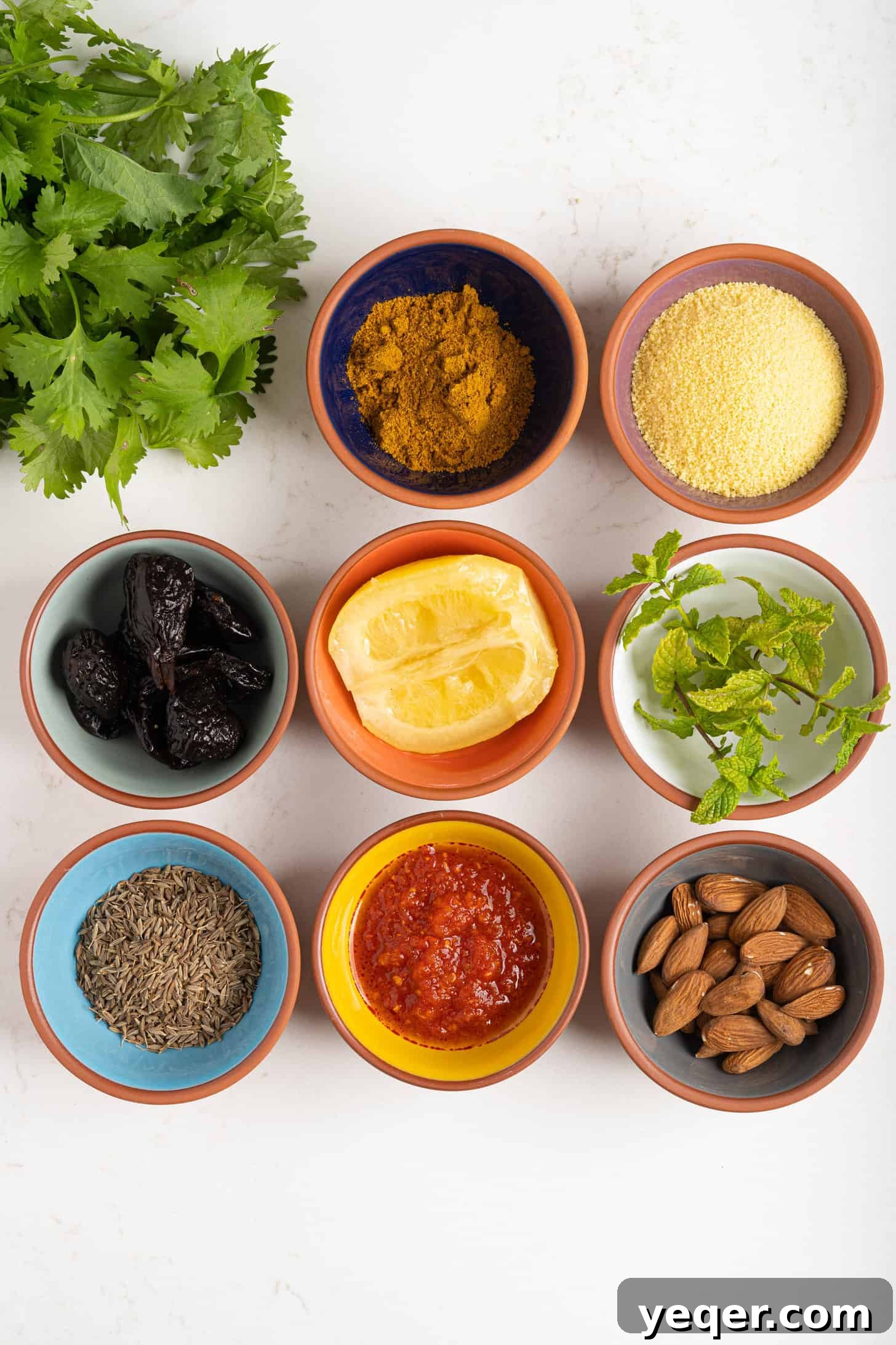 Unveiling Moroccan Flavors: Over Two Dozen Authentic Recipes 2 A vibrant display of Moroccan key ingredients, including various spices, preserved lemons, fresh herbs, olives, and a tagine, hinting at the rich flavors of Moroccan cuisine.