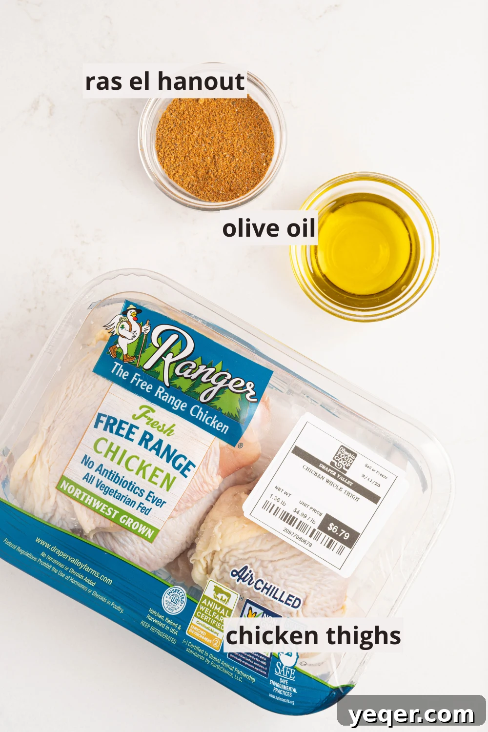Effortless Ras El Hanout Chicken Thighs Three Ingredients 3 Bowls of golden Ras el Hanout spice blend and olive oil are ready next to fresh chicken thighs, illustrating the simple yet potent ingredients for this Moroccan dish.