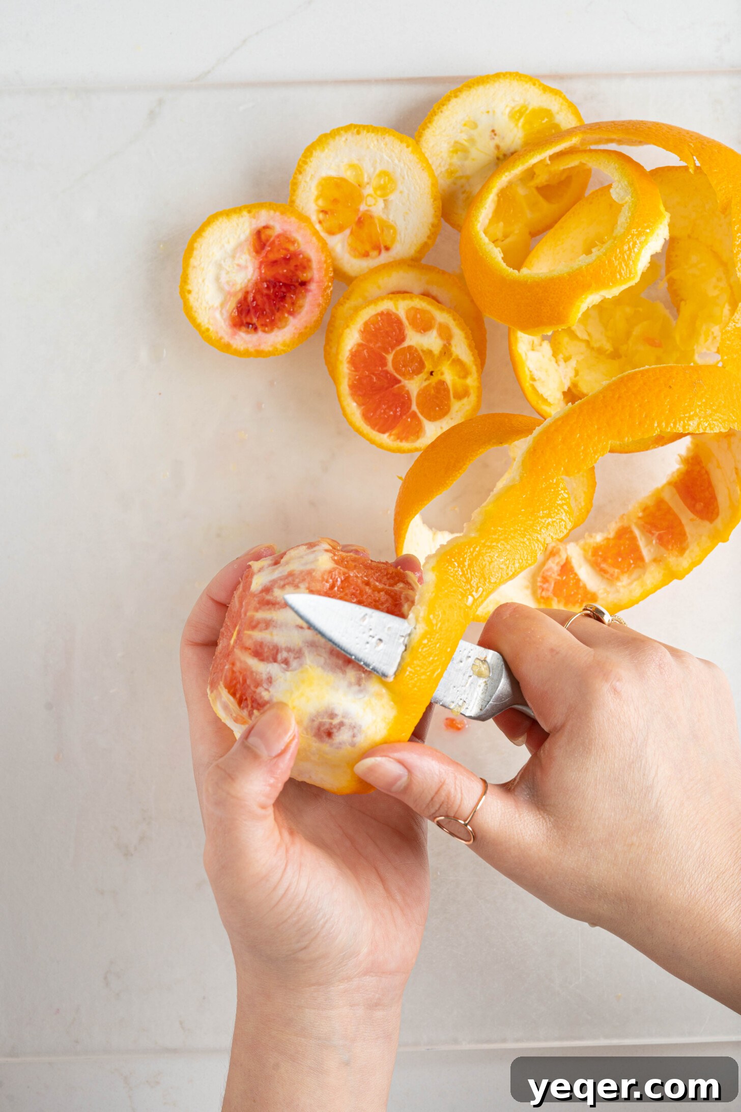 Quick Moroccan Orange Salad with Cinnamon Spice 13 Hands demonstrating precise peeling and slicing of an orange for the salad.