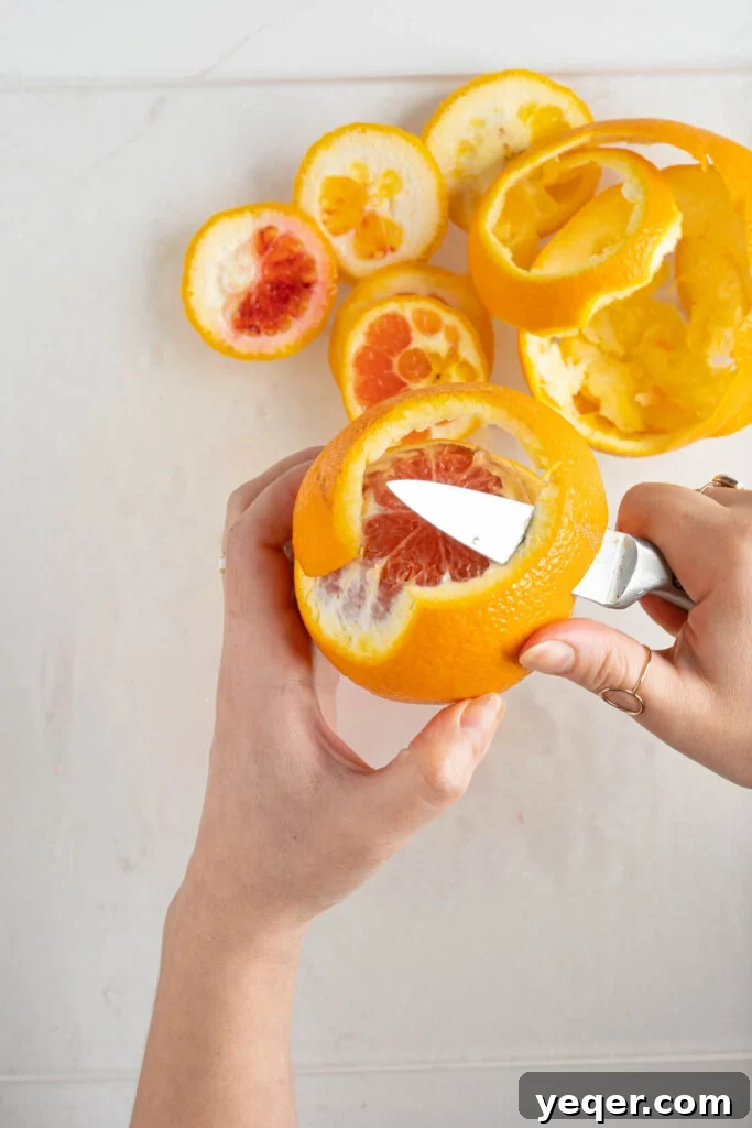 Quick Moroccan Orange Salad with Cinnamon Spice 4 Hands demonstrating how to peel an orange cleanly using a paring knife, removing both peel and pith.