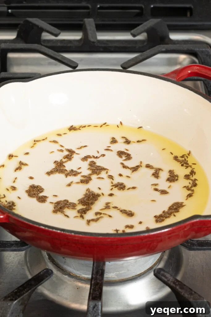 Speedy Moroccan Shakshuka 4 cumin seeds with oil in a pan on a stovetop