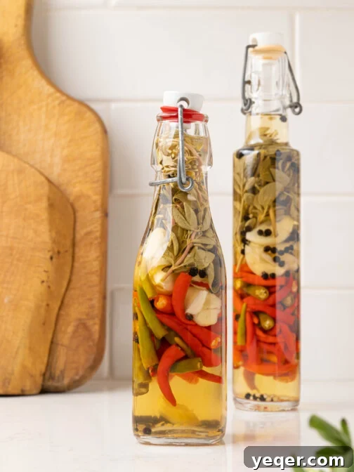 two bottles of hot sauce on a white counter