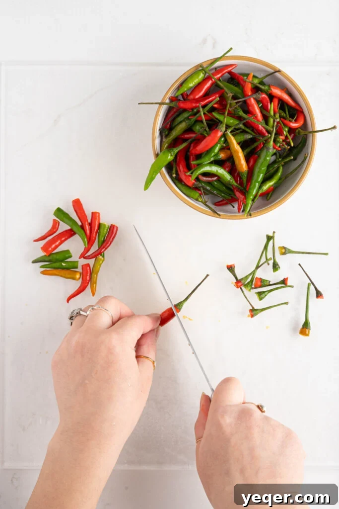 Boricua Flash Pique 4 two hands cutting chile peppers with a knife