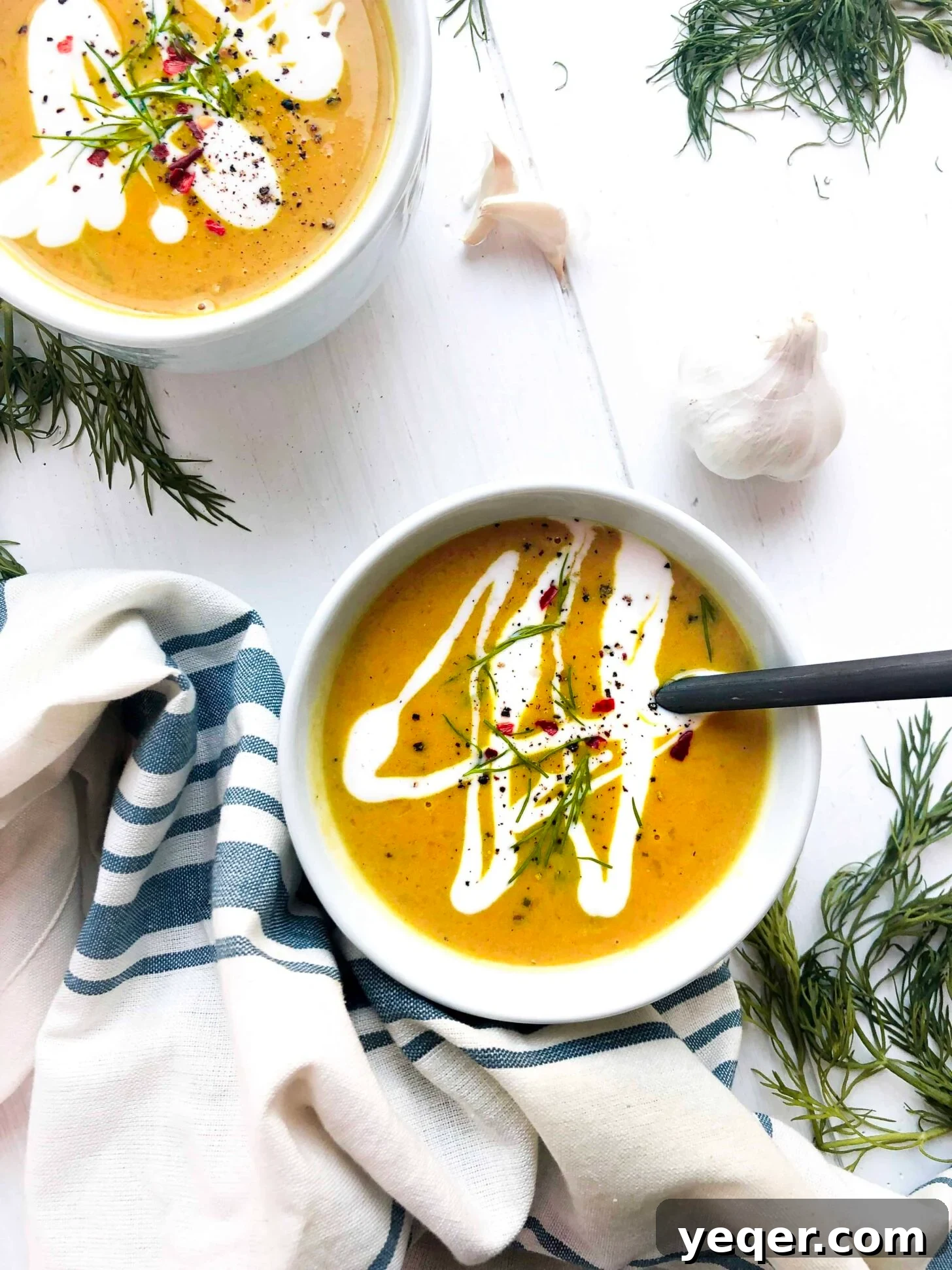 Velvety Vegan Butternut Squash Soup 2 A beautiful bowl of creamy vegan butternut squash soup, garnished with fresh herbs and a drizzle of coconut cream, ready to be enjoyed.
