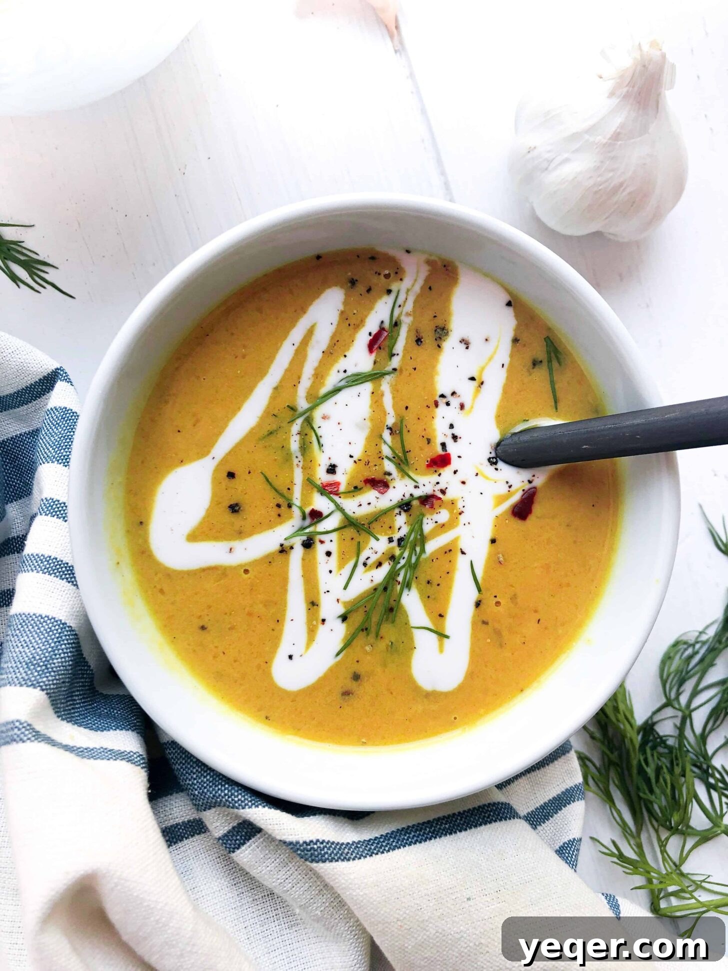 Velvety Vegan Butternut Squash Soup 4 A close-up of a steaming bowl of vegan butternut squash soup, showcasing its smooth texture and vibrant color, garnished elegantly.