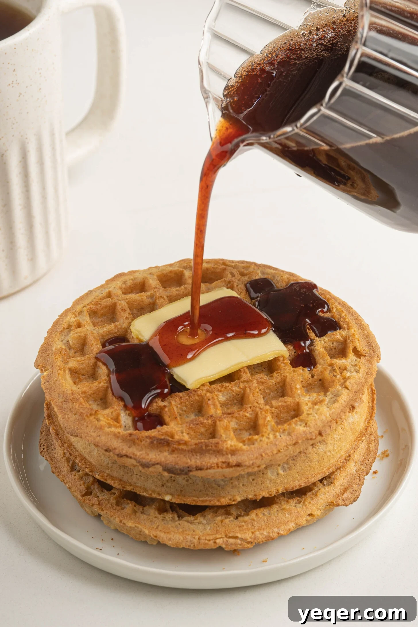 Pure Date Nectar 11 Close-up of golden date syrup pouring over a stack of warm, fluffy waffles