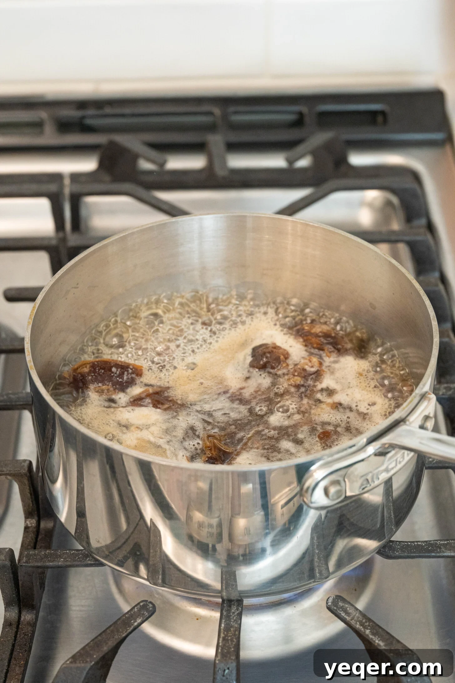 Pure Date Nectar 16 Dates boiling with water in a pot on the stove