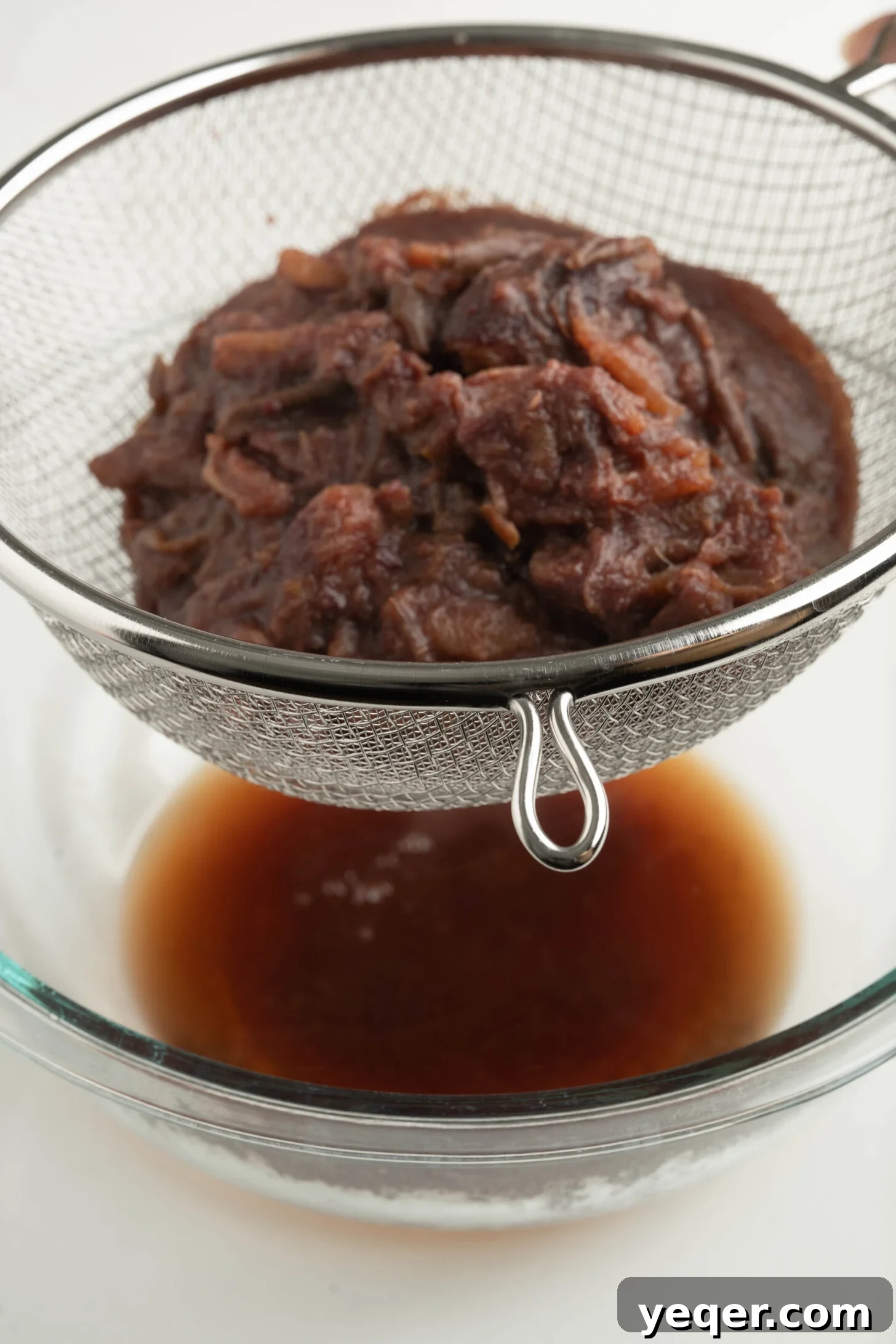 Pure Date Nectar 17 Date pulp being strained into a bowl