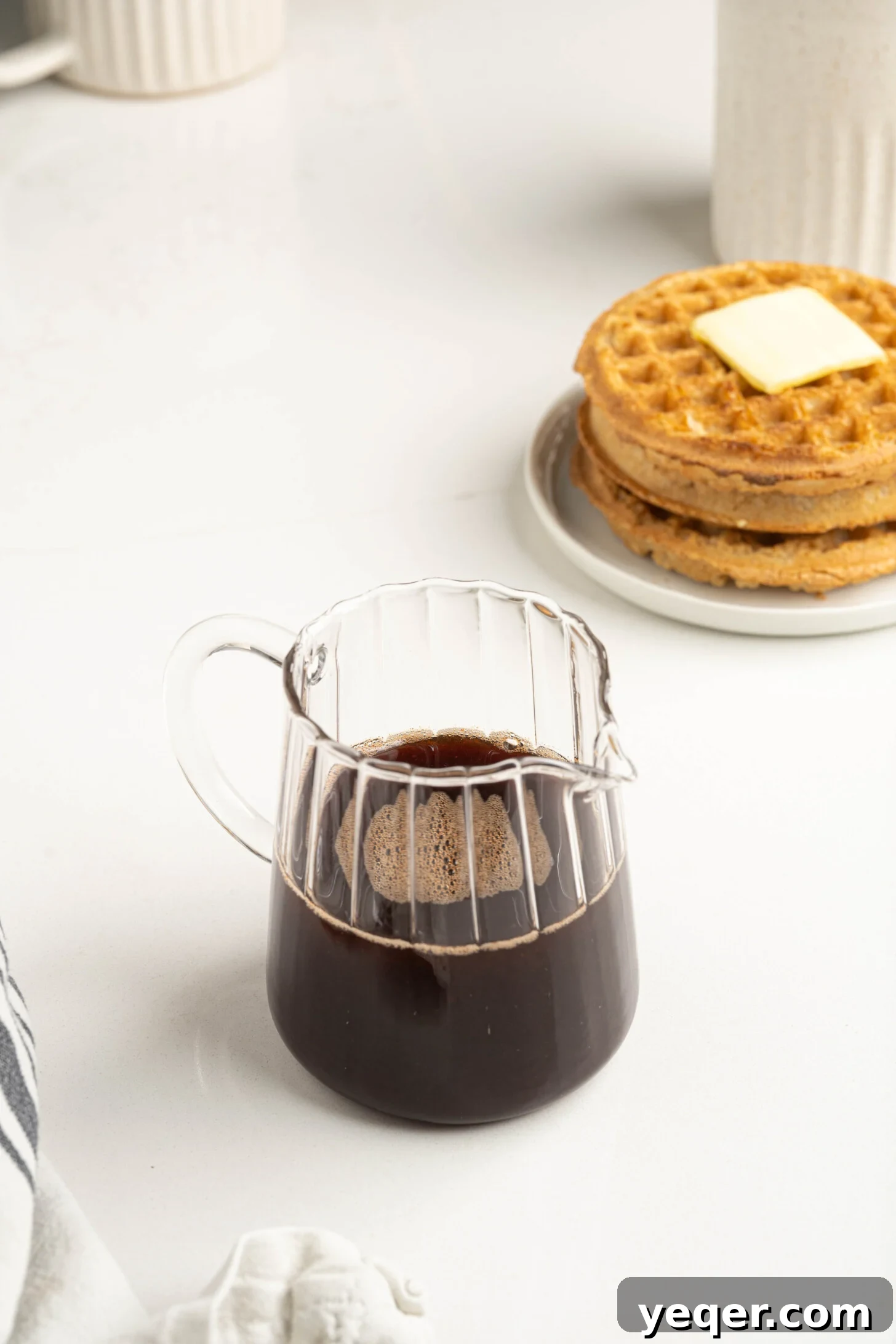 Pure Date Nectar 18 Date syrup in a glass bottle with waffles in the background