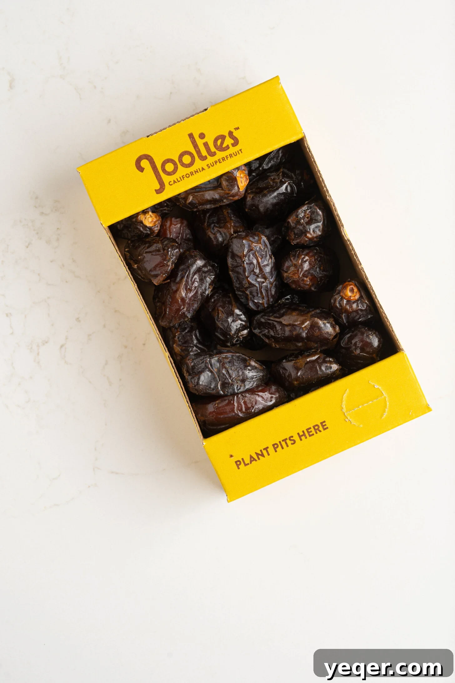 Pure Date Nectar 4 A box of premium Medjool dates resting on a kitchen counter, ready for syrup preparation
