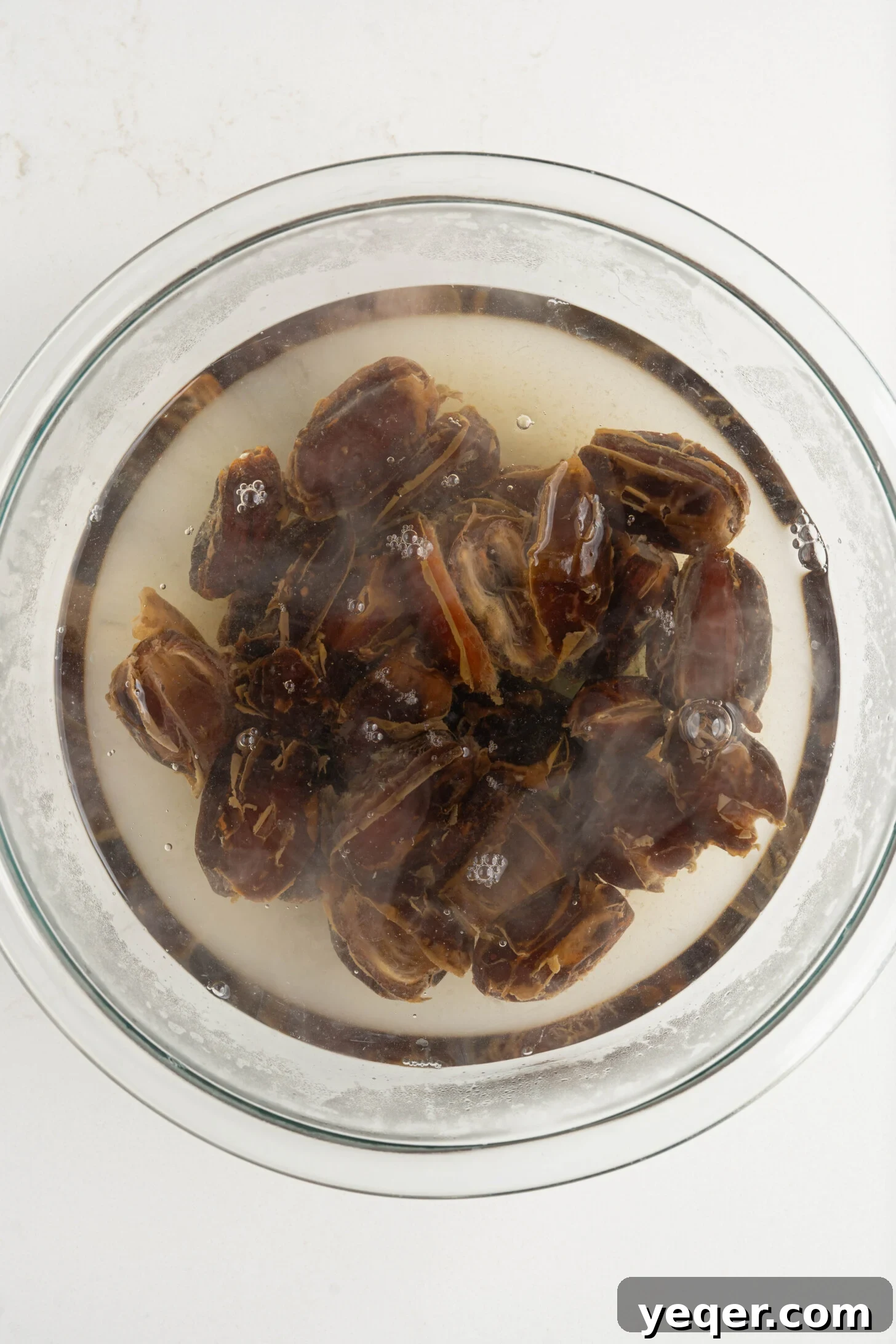 Pure Date Nectar 6 Pitted dates steeping in a bowl of hot water