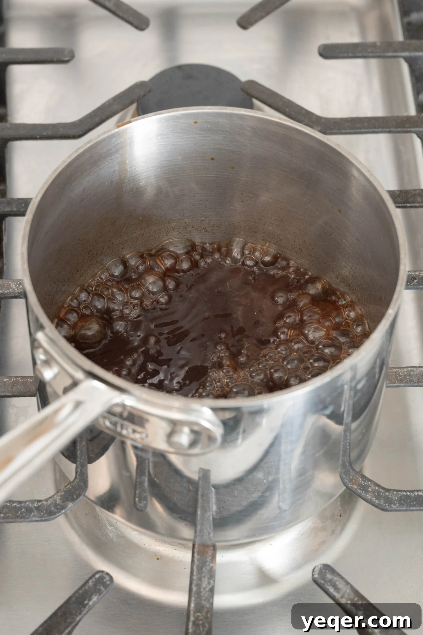 Pure Date Nectar 9 The strained date liquid simmering in a pot on the stovetop to reduce